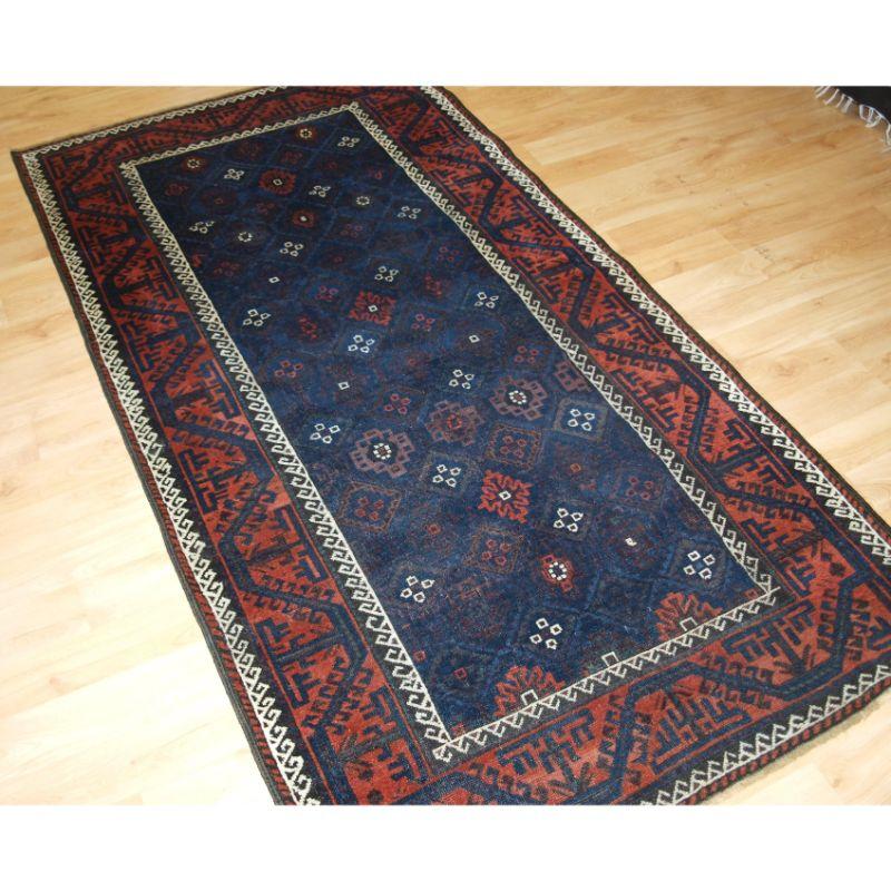 A superb 19th century Baluch rug from Western Afghanistan with a diamond lattice design containing a 