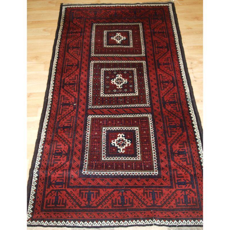 Antique Baluch rug with three compartments. A Baluch rug with good traditional Baluch colours with a traditional Baluch boat border.

A good Baluch rug with interesting design, the colour combinations work very well, the use of ivory high lights