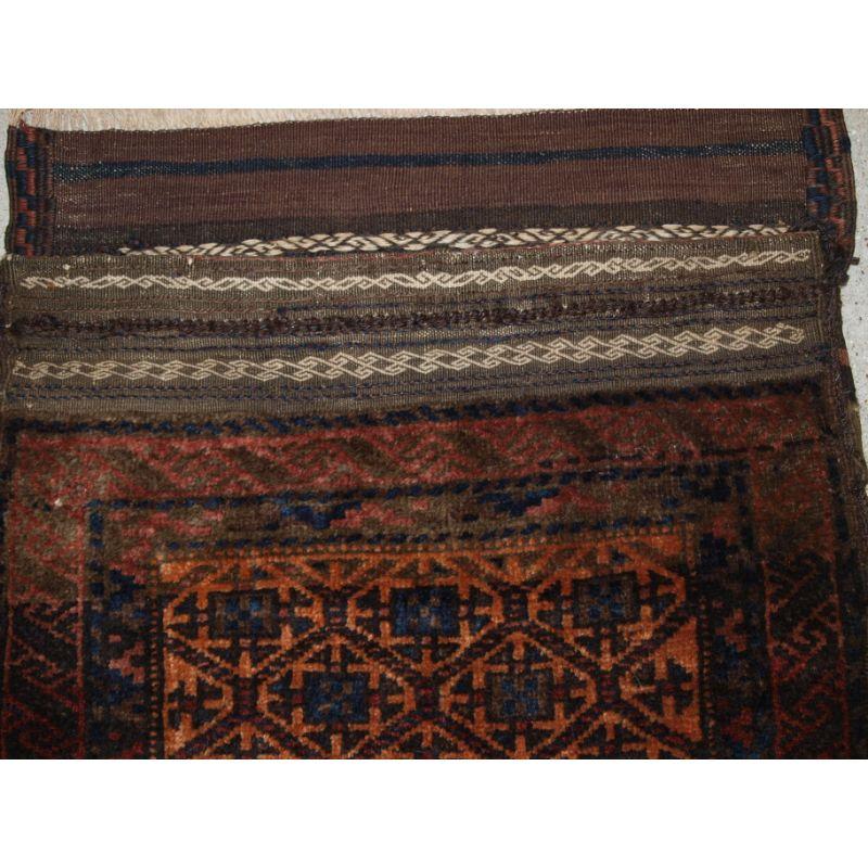 Antique Baluch saddle bag with plain weave back. Western Afghanistan.

The saddle bag is of lattice design with Turkmen related design elements.

The saddle bag is in excellent condition with very slight even wear and full pile. Note the