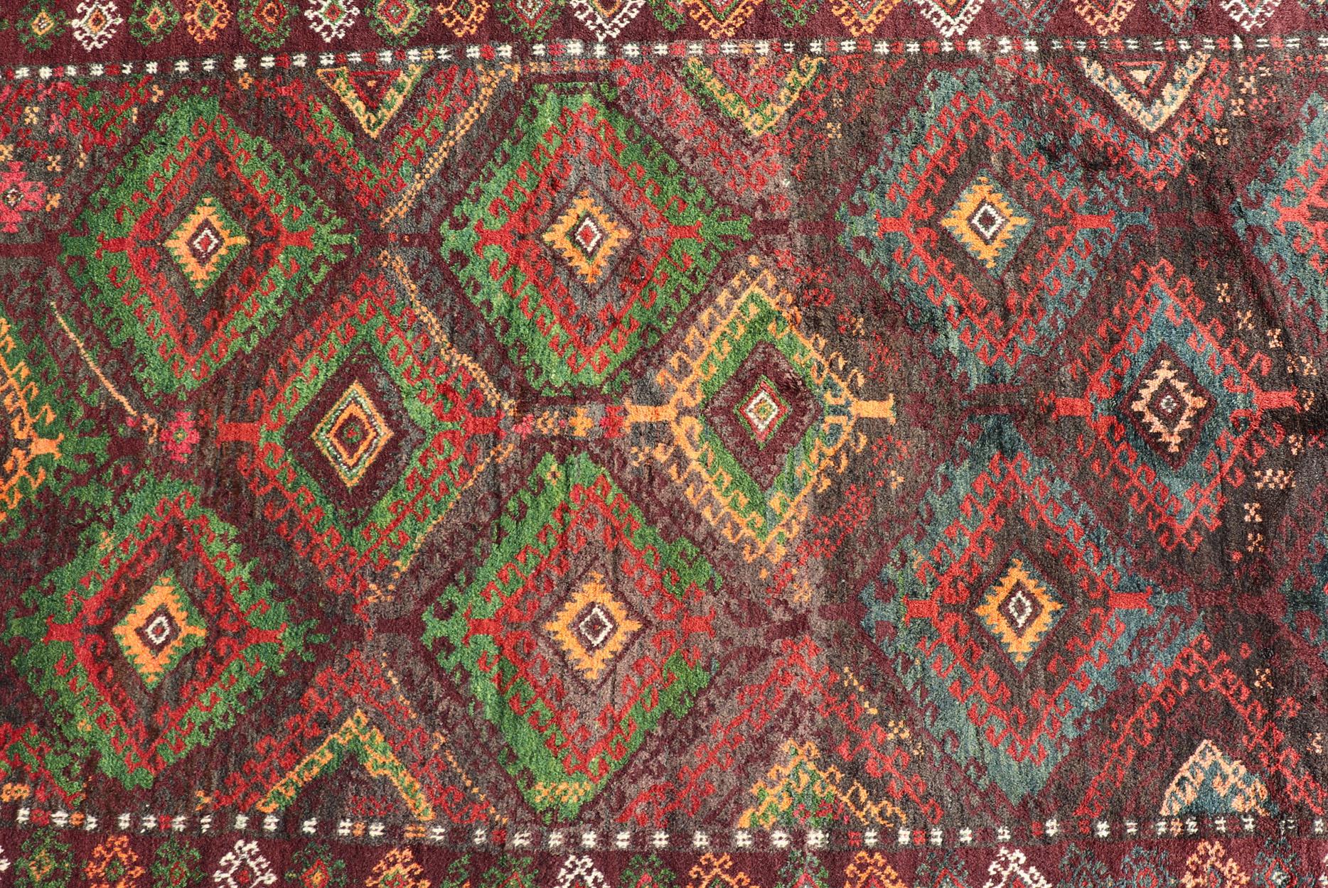 Antique Baluch tribal rug with all-over geometric in colorful design and motifs. Keivan Woven Arts, rug EMB-9680-P13558; country of origin / type: Iran / Baluch, circa 1930s.

This Antique Baluch Rug has been hand-knotted and features an
