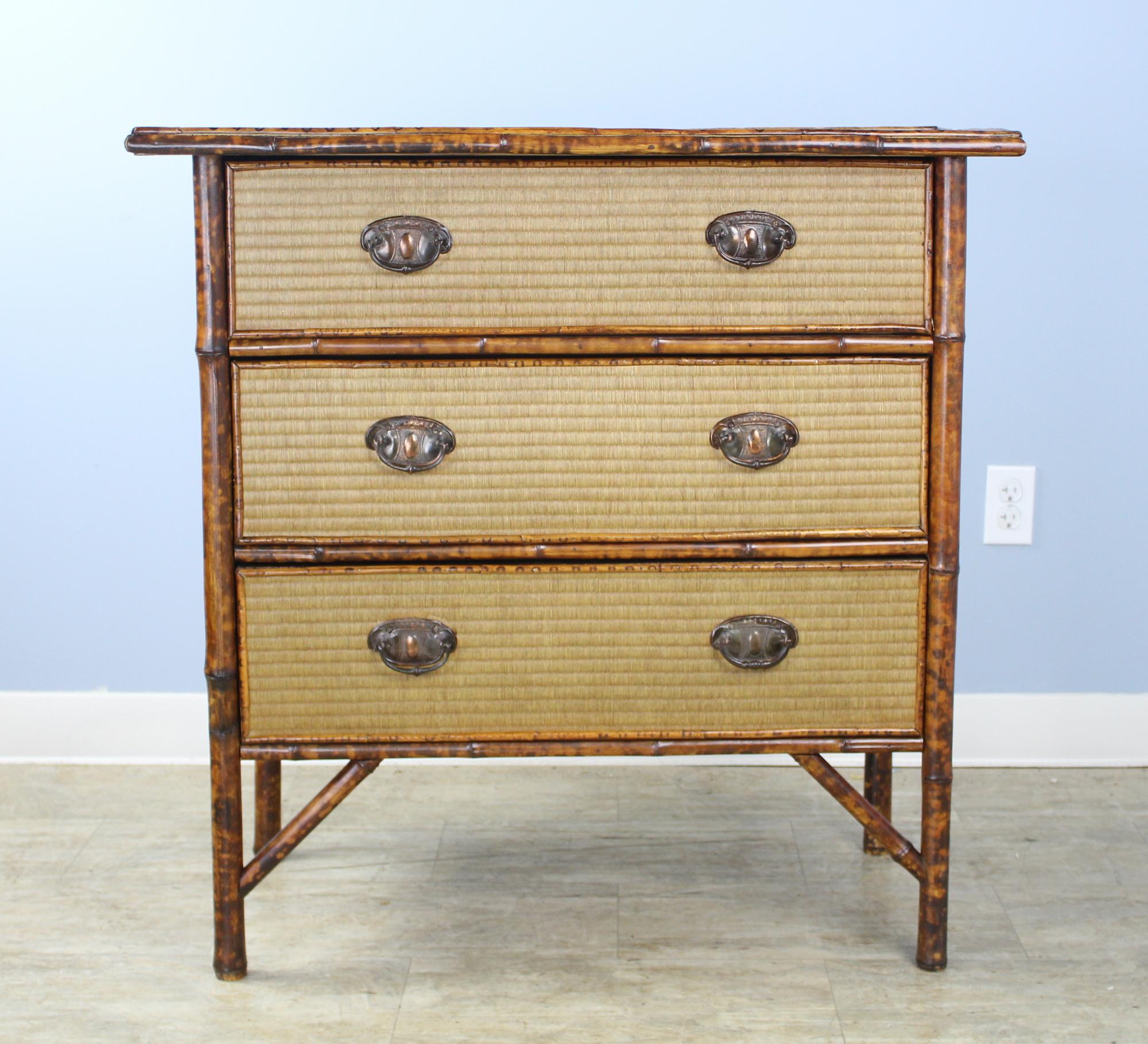 A smart and highly decorative bamboo and rattan chest of drawers. The rattan is in very good condition as is the vibrant bamboo. An excellent choice for a country bedroom or hall. Brass escutcheons may not be original but complement the style and