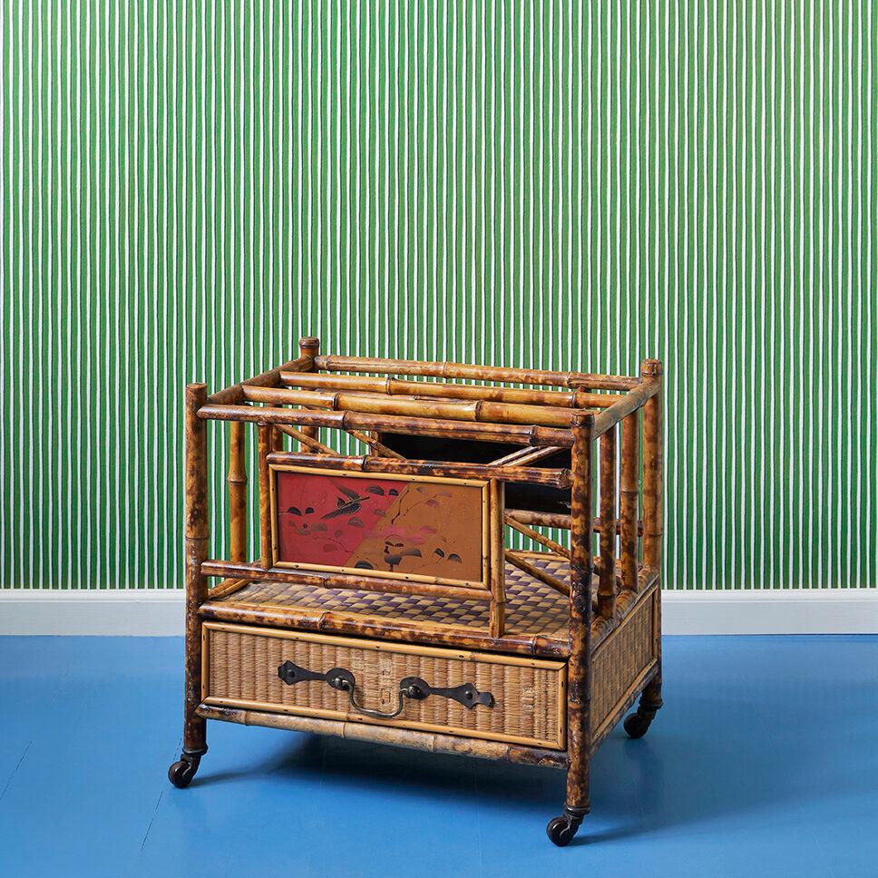 England, 1890's

Late Victorian bamboo and rattan magazine rack with chinoiserie hand painted panels and a rattan lined drawer with brass fittings to base. All standing on brass and porcelain castors. 

Measures: H 50 x W 51 x D 35 cm.