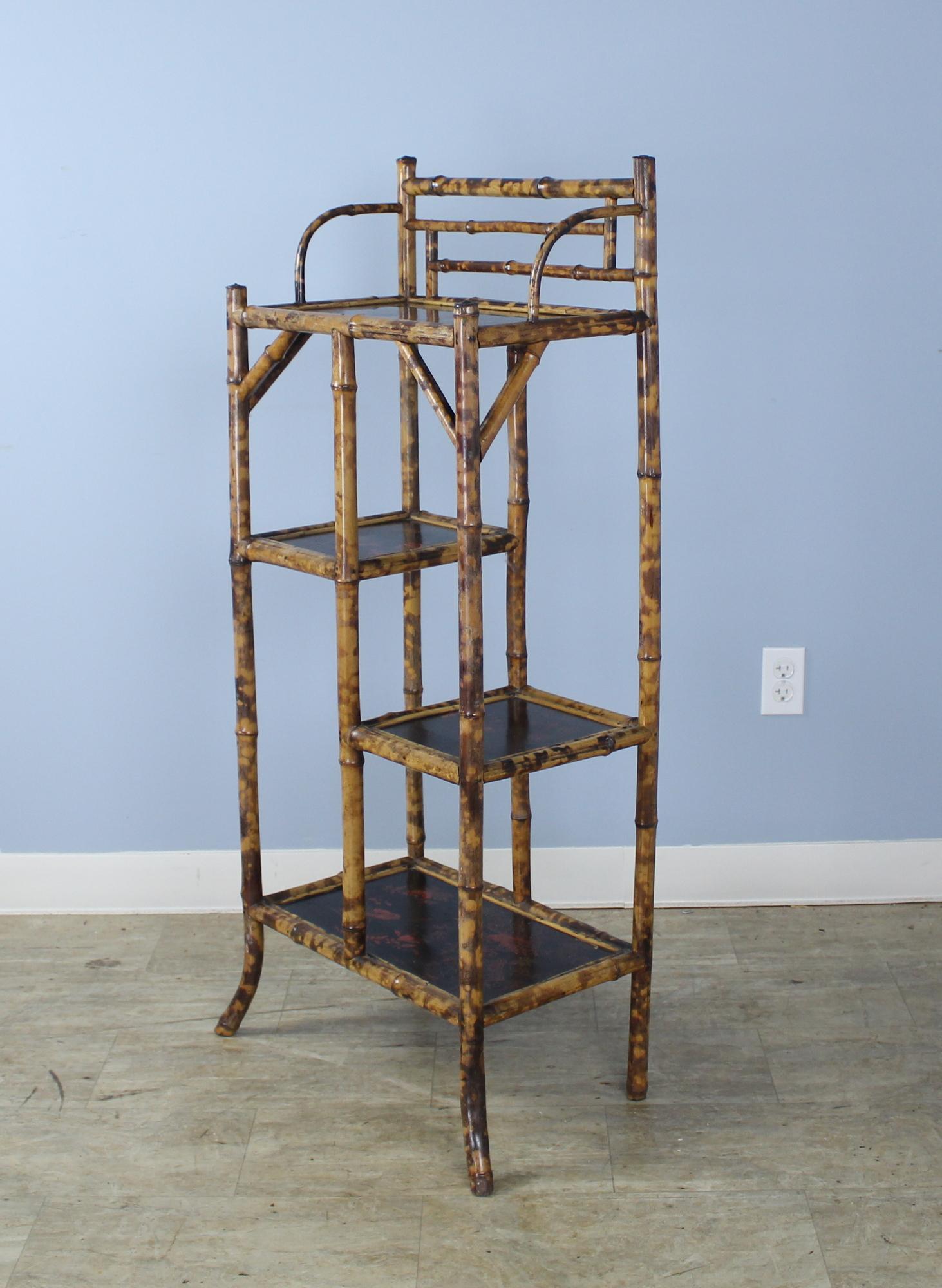 A highly decorative bamboo etagiere, bookcase or rack with terrific chinoiserie floral and bird lacquered shelves. The bamboo is vibrantly painted and in good antique condition. Piece is very stable and versatile.