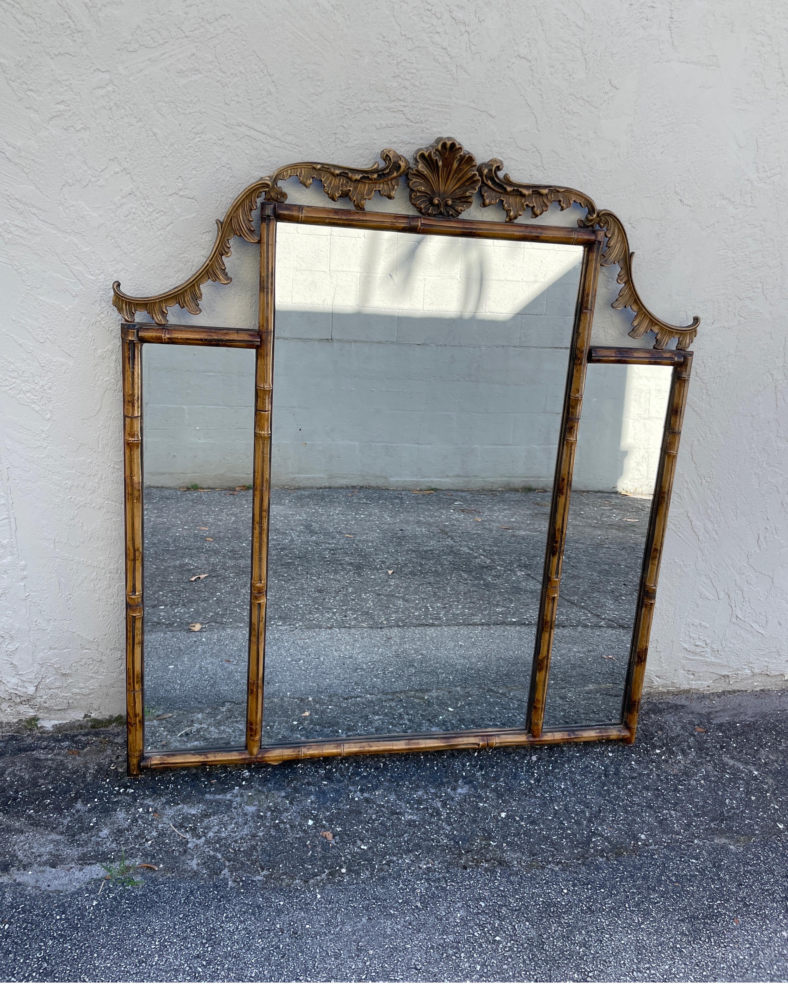 19th century bamboo over mantel mirror. This mirror consists of three bamboo framed panels with a detailed cornice on top. Crowned in the middle with a shell. A rare and unique mirror that will be outstanding wherever you place it.