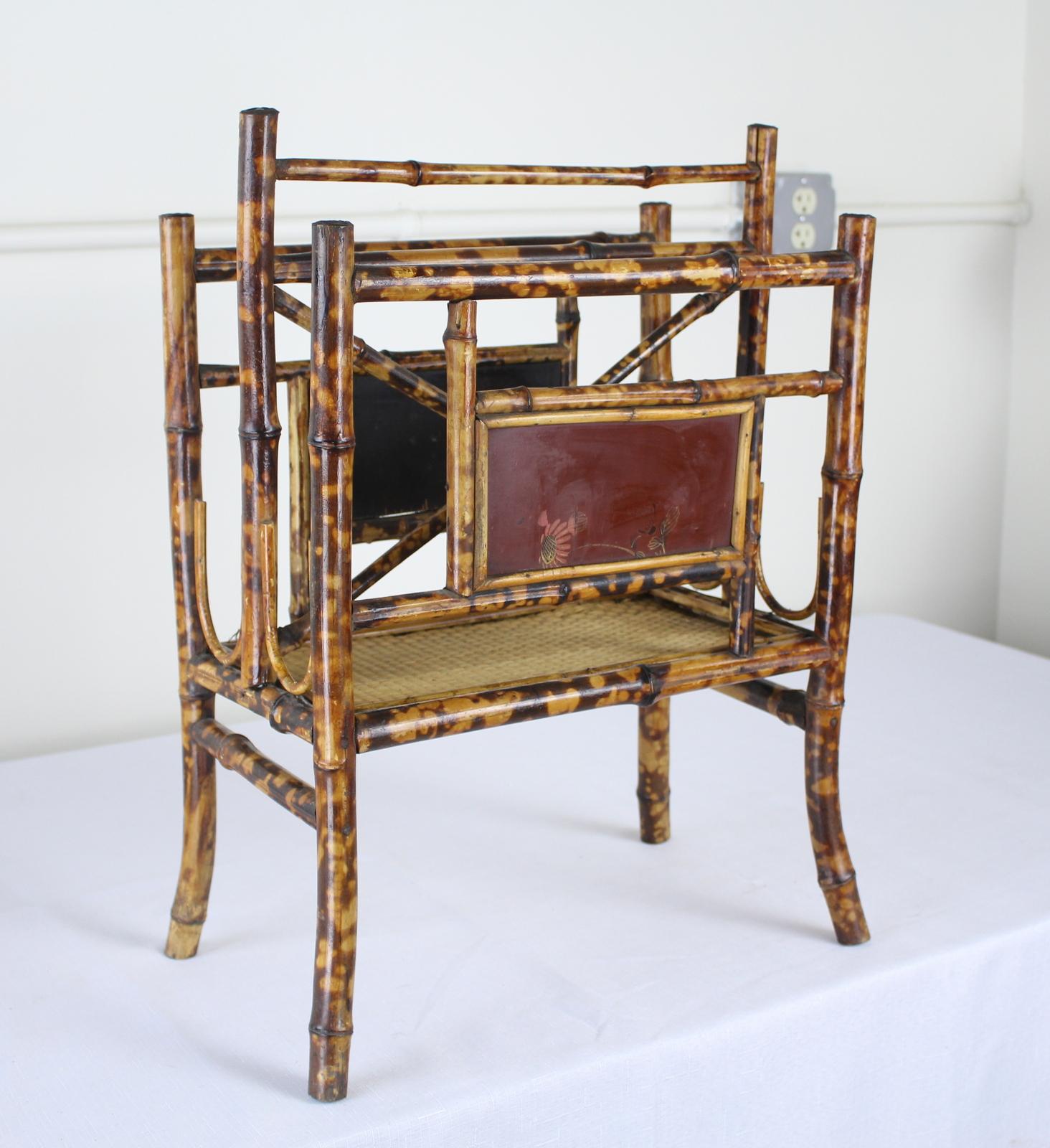 Antique bamboo canterbury from England, originally designed to hold sheet music, but perfect as a magazine rack. There is some wear on the original lacquer chinoiserie.