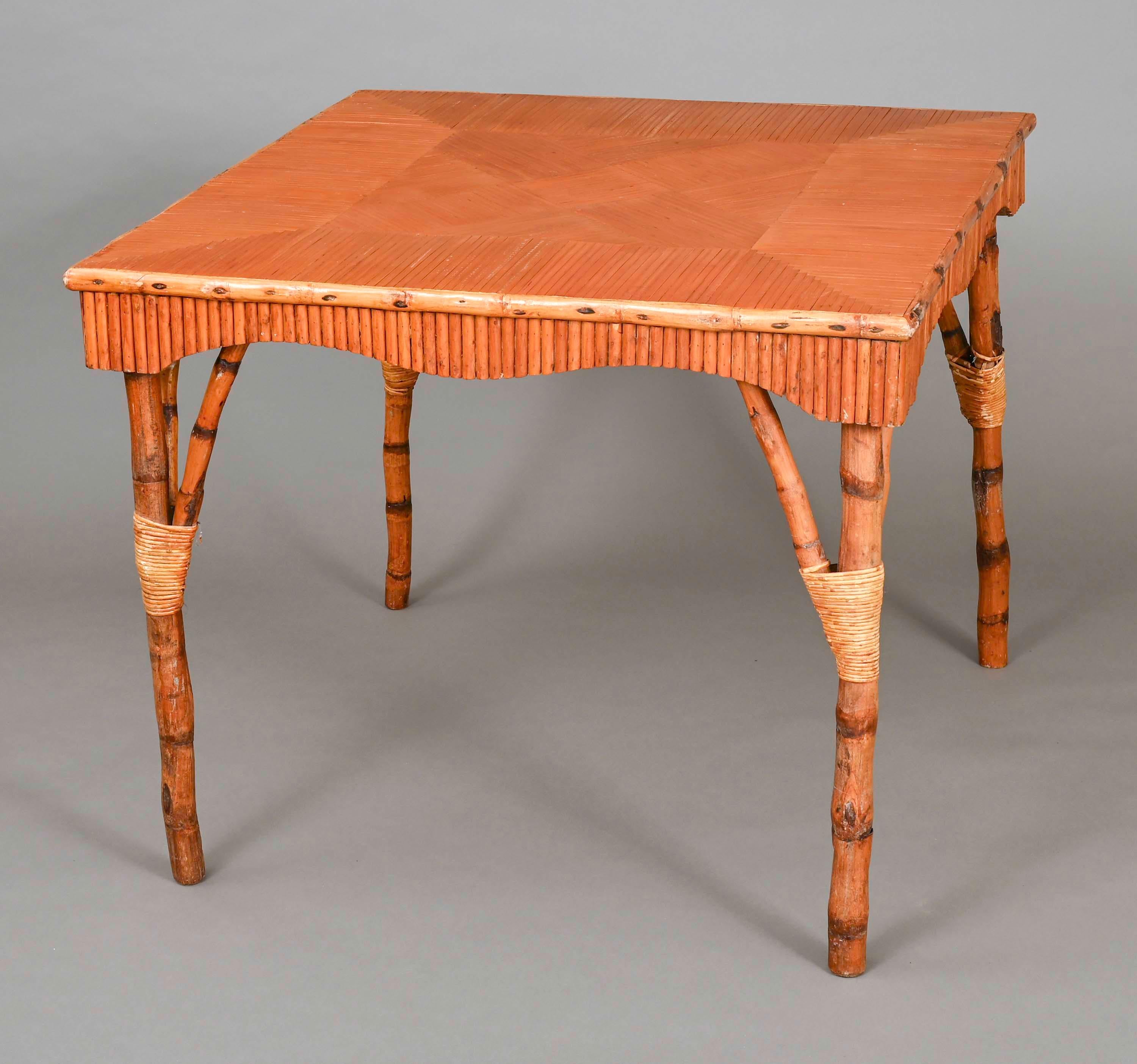 Wonderful antique bamboo square table from early 1920s. 36” square solid wood tabletop base veneered with split bamboo laid out in square patterns. Cut bamboo in soft wave pattern for aprons. Legs are solid bamboo, joined with bamboo wraps.
Great