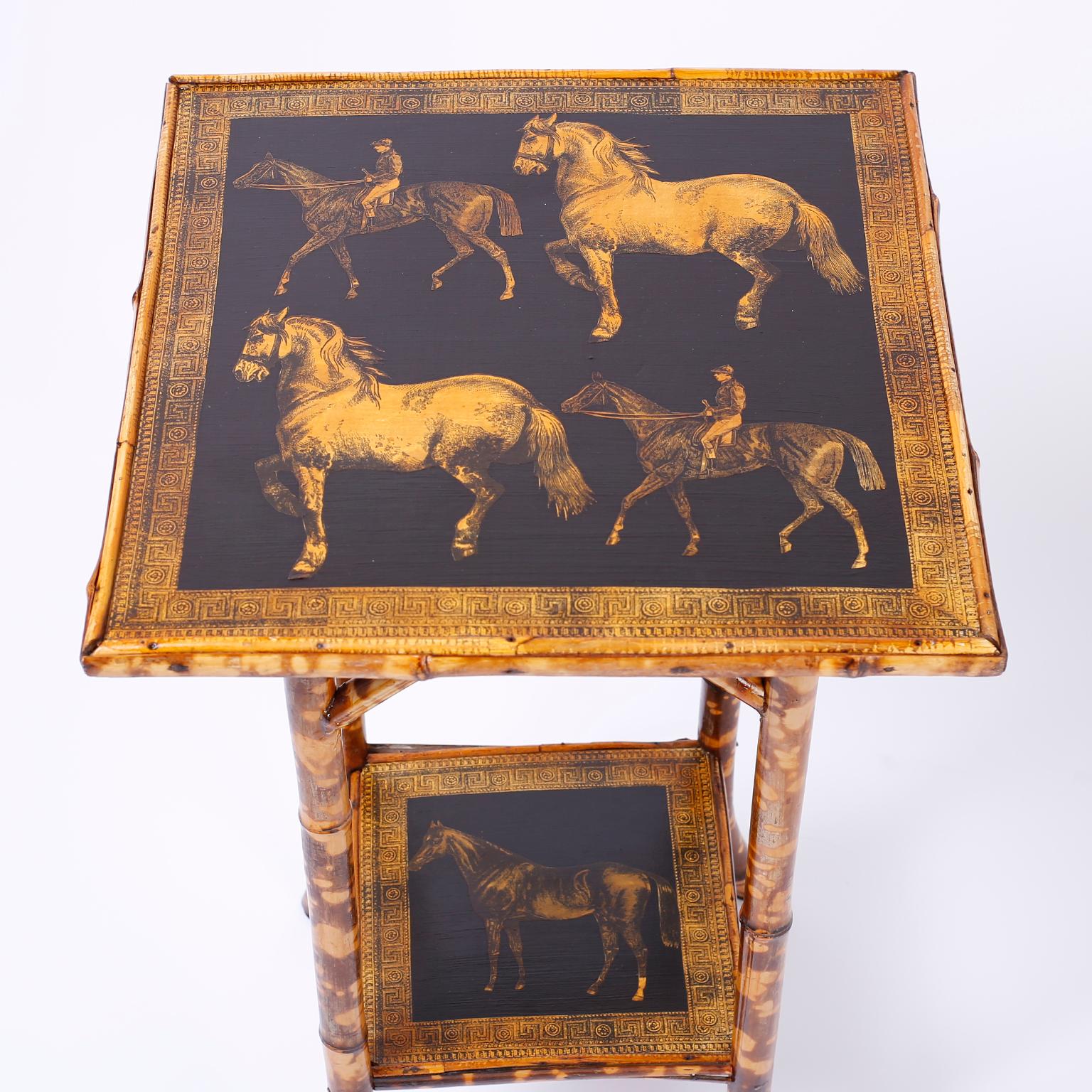 Striking antique English bamboo table ingeniously decorated with contemporary decoupage horses and a rider on the top and lower tier.
     