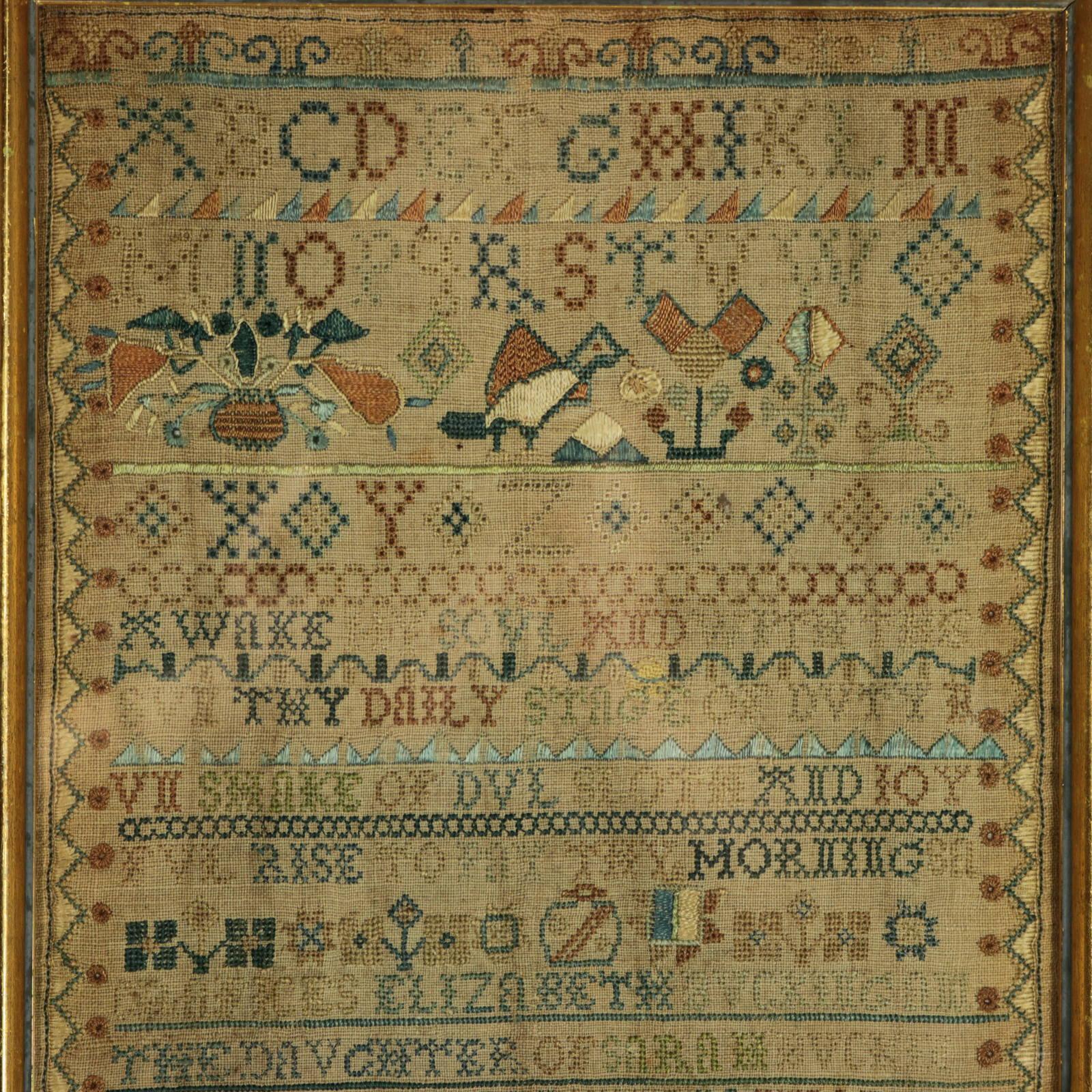 1741 Band Sampler by Elizabeth Buckingam. The sampler is worked in silk and linen ground, in a variety of stitches including Algerian eye. Decorated border and divider lines in various patterns. Colours gold, green, light brown, dark brown, purple,