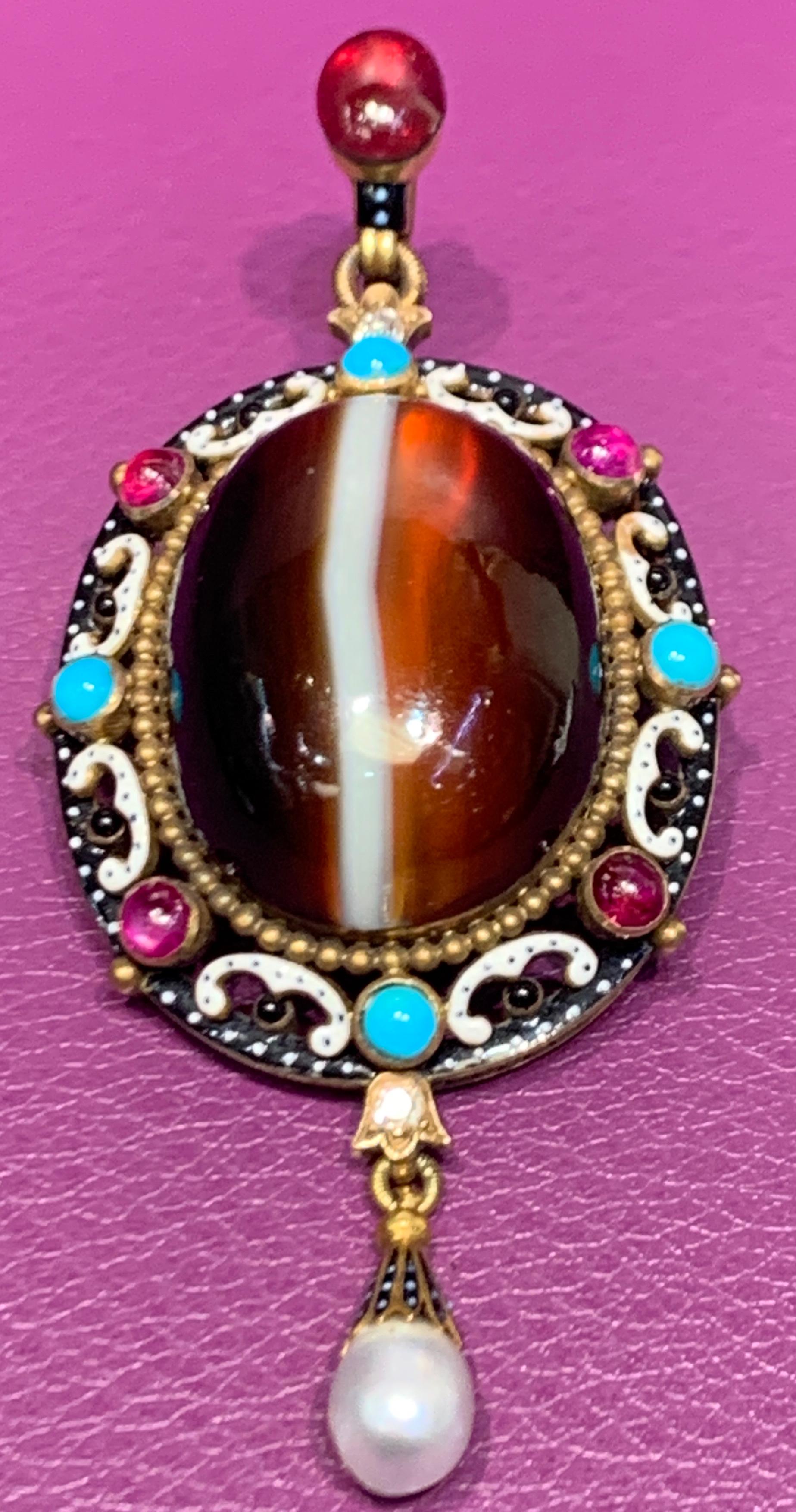 Antique Agate & Multi Gem Gold Brooch with black & white enamel
Renaissance Revival
2 diamonds
5 rubies
4 turquoise
1 pearl
Measurements: 3 inches long
Accompanied with original Phillips fitted box
Made circa 1900
