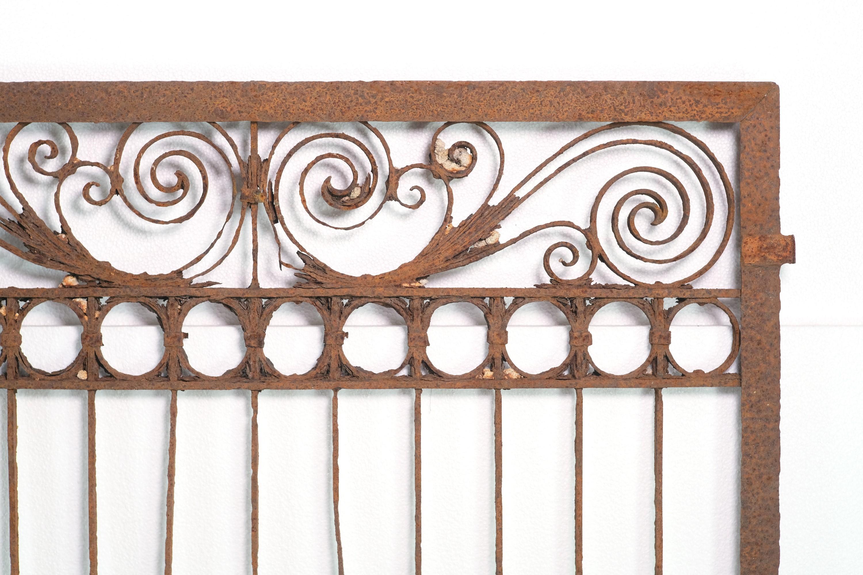 Original Antique late 1800s wrought iron fence wall divider. Manufacturing with banding and pinned pieces. Features ornate curls and spirals. Some bends with lots of rust. Minor missing pieces. Please see photos. This can be seen at our 400 Gilligan
