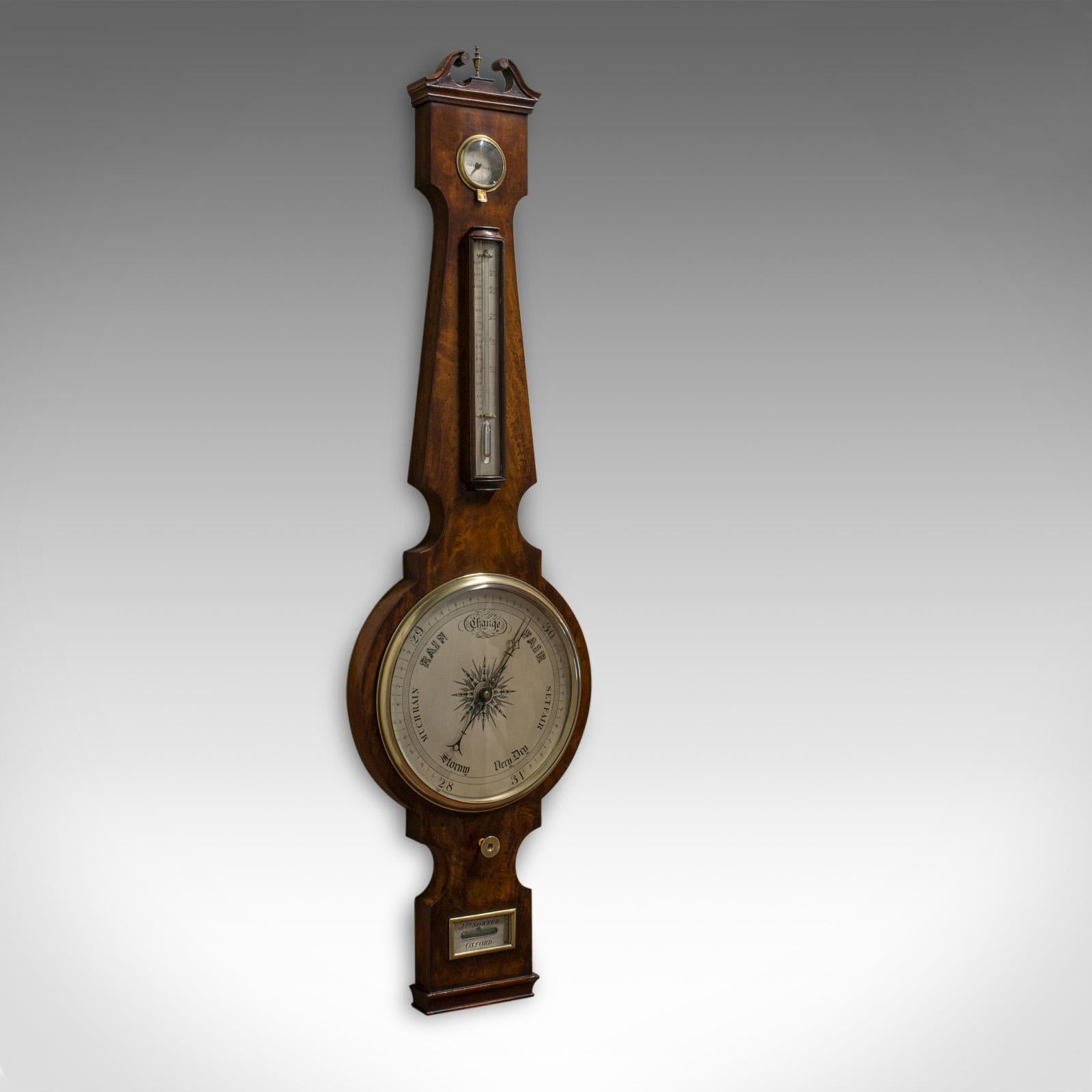 This is an antique banjo barometer. An English, mahogany barometer by John Sowter of Oxford and dating to the Victorian period, circa 1850.

Rich mahogany hues and a desirable aged patina
Bright, clear barometer glass in good order
Brass finial