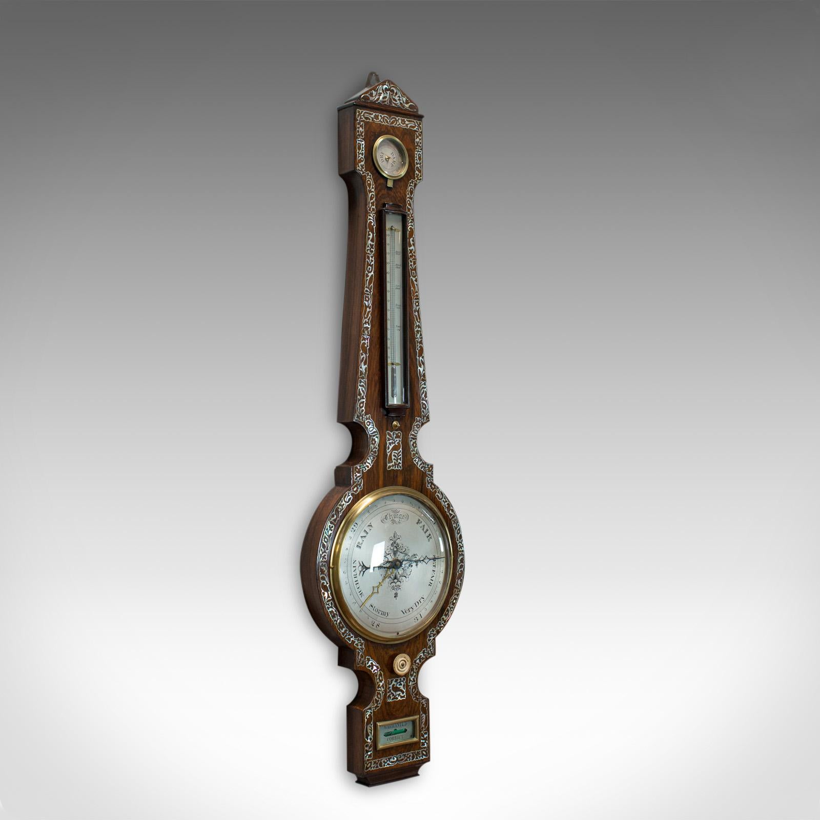 This is an antique banjo barometer. An English, rosewood and mother of pearl barometer dating to the Victorian period in the late 19th century, circa 1900.

Select rosewood displays wonderful grain interest and a desirable aged patina
Profusely