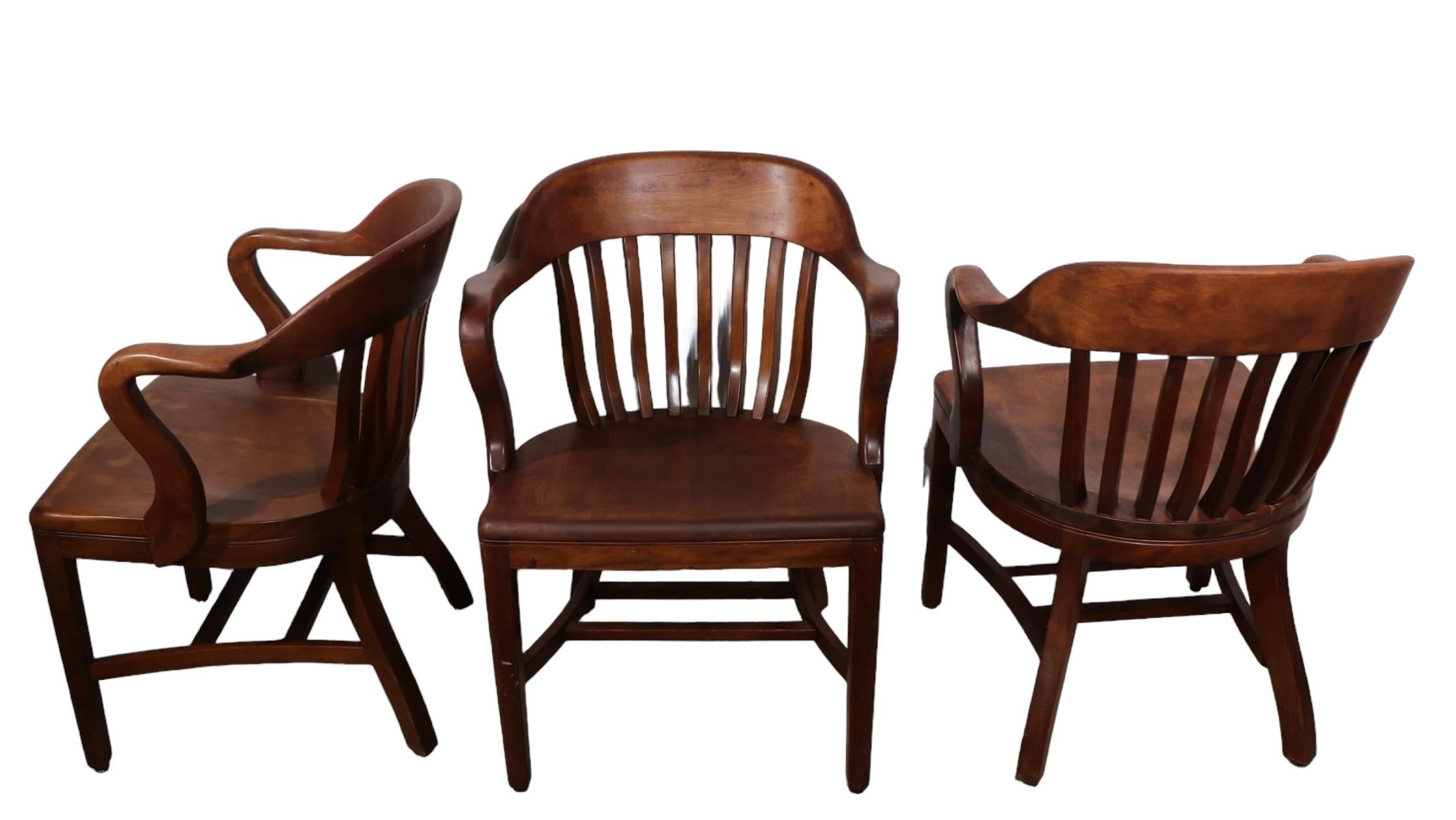 Classic Bank of England, Jury, Yale Library chair(s) constructed of solid walnut . The chairs feature the more desirable continuous curved arm, back rest form. All three are in very good, clean, ready to use condition, showing only light cosmetic