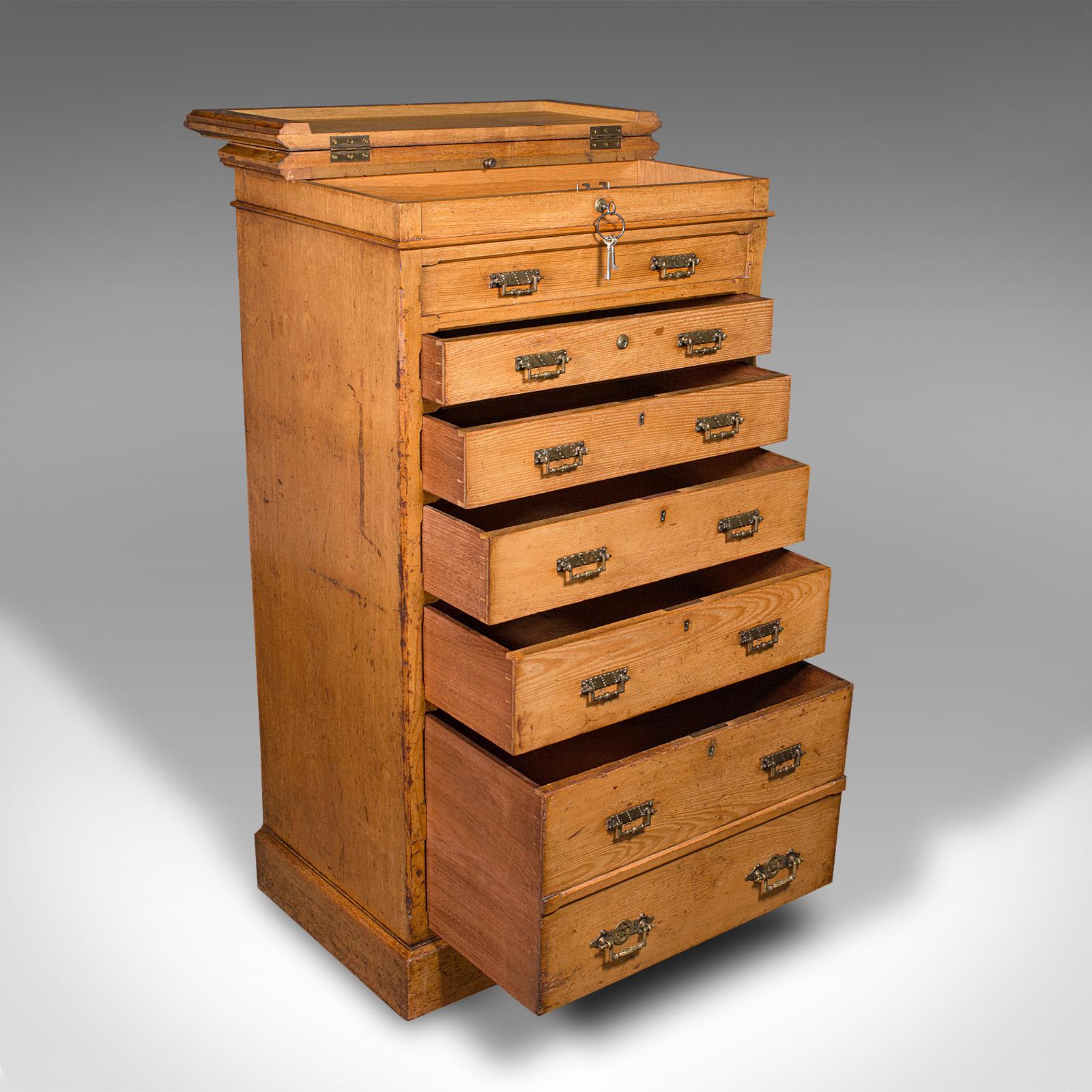 This is an antique banker's chest of drawers. An English, oak tallboy in Aesthetic Period taste by Maple & Co, dating to the late Victorian period, circa 1890.

Exceptional craftsmanship with rich colour and a suite of features
Displays a desirable