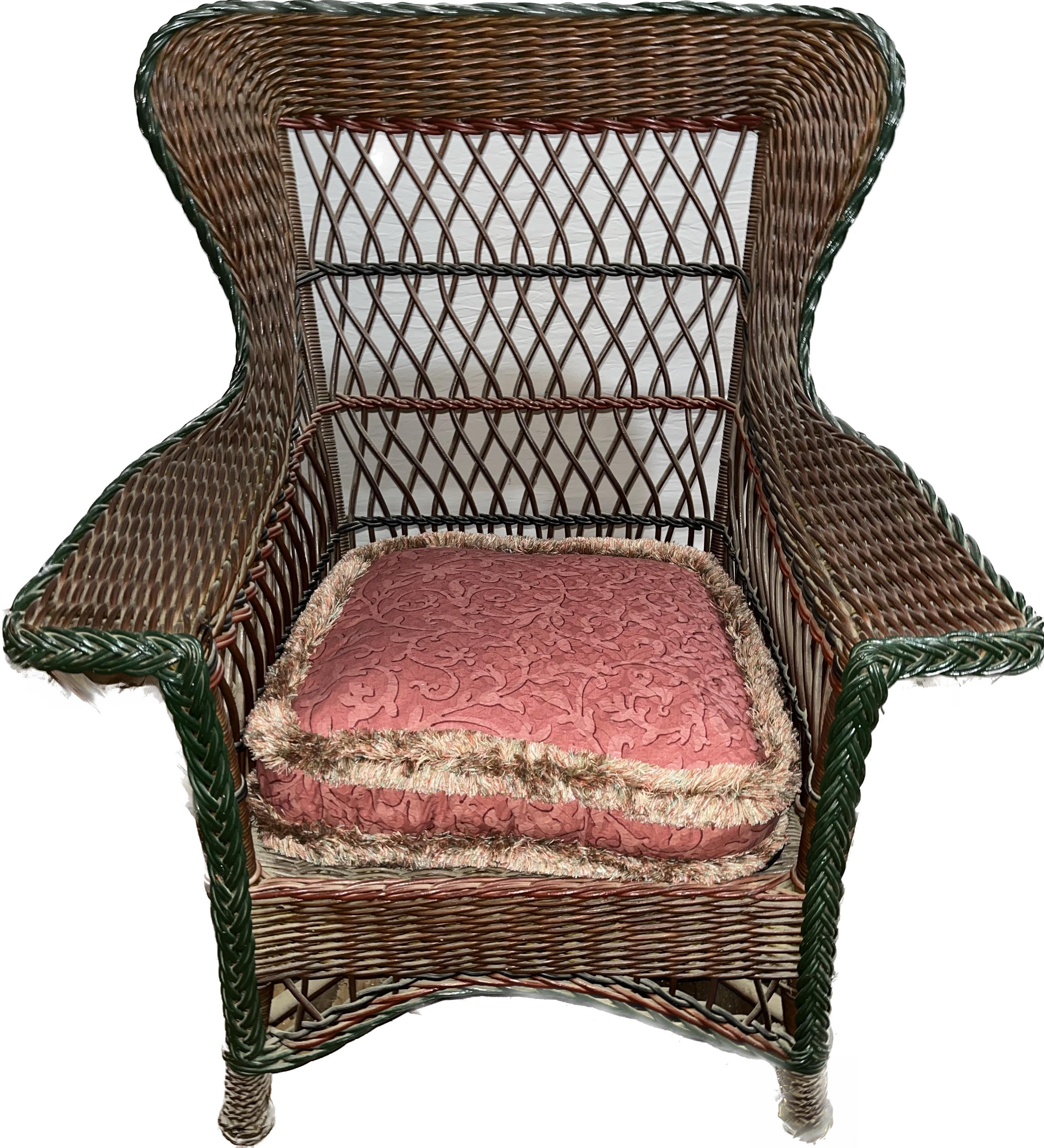 A beautiful, antique Heywood Wakefield, Bar Harbor style wicker wing chair, recently acquired from a private estate. It is done in natural finish with green accent trim, American, circa 1900-1910. Large and incredibly sturdy with lovely wide arms