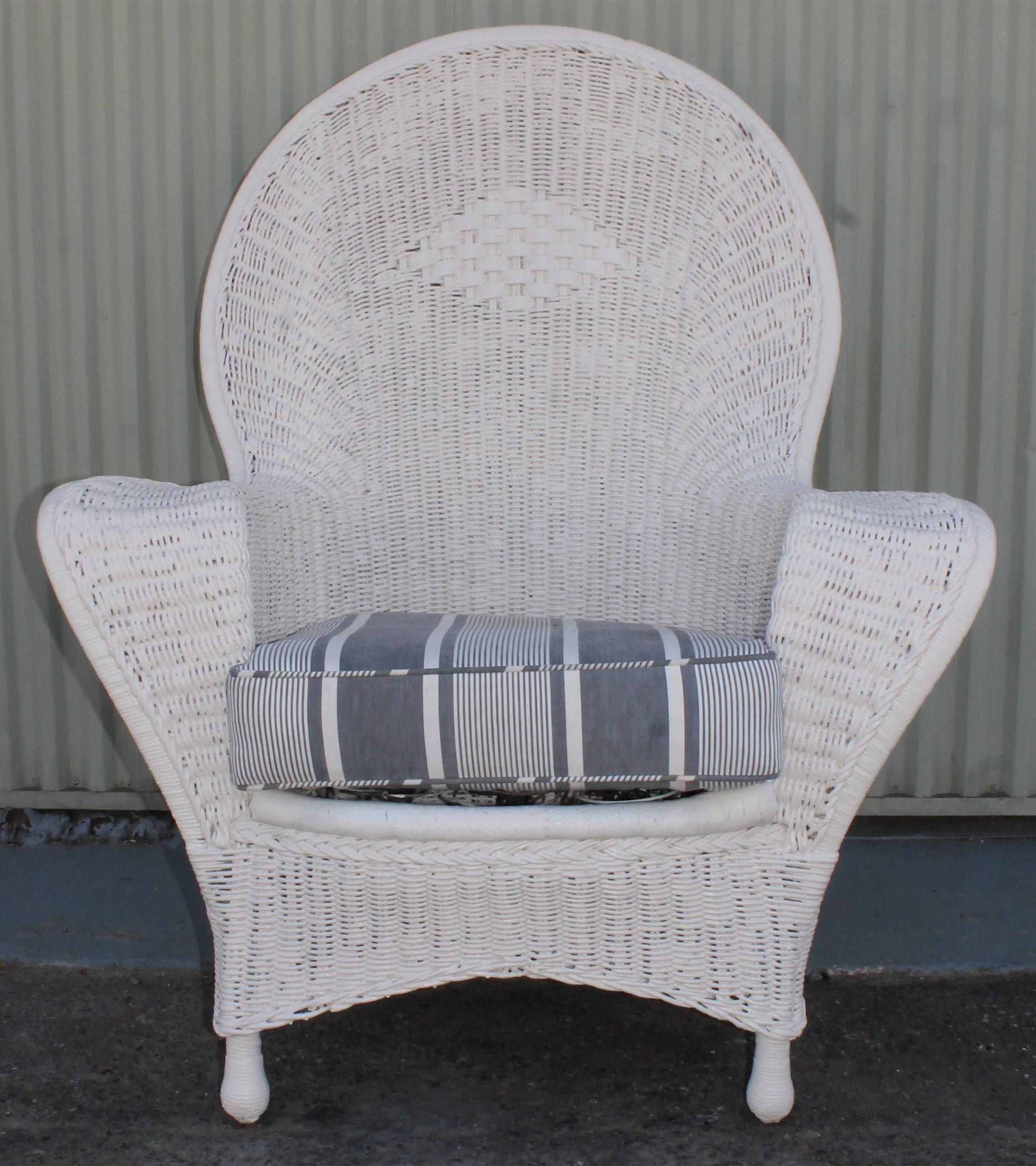 Stunning over painted American wicker fan back chair with spring seats and ticking pillow as cushion. This chair comes with a 19th century black and white faded ticking cushion. The condition on this oversize bar harbor chair is very good and