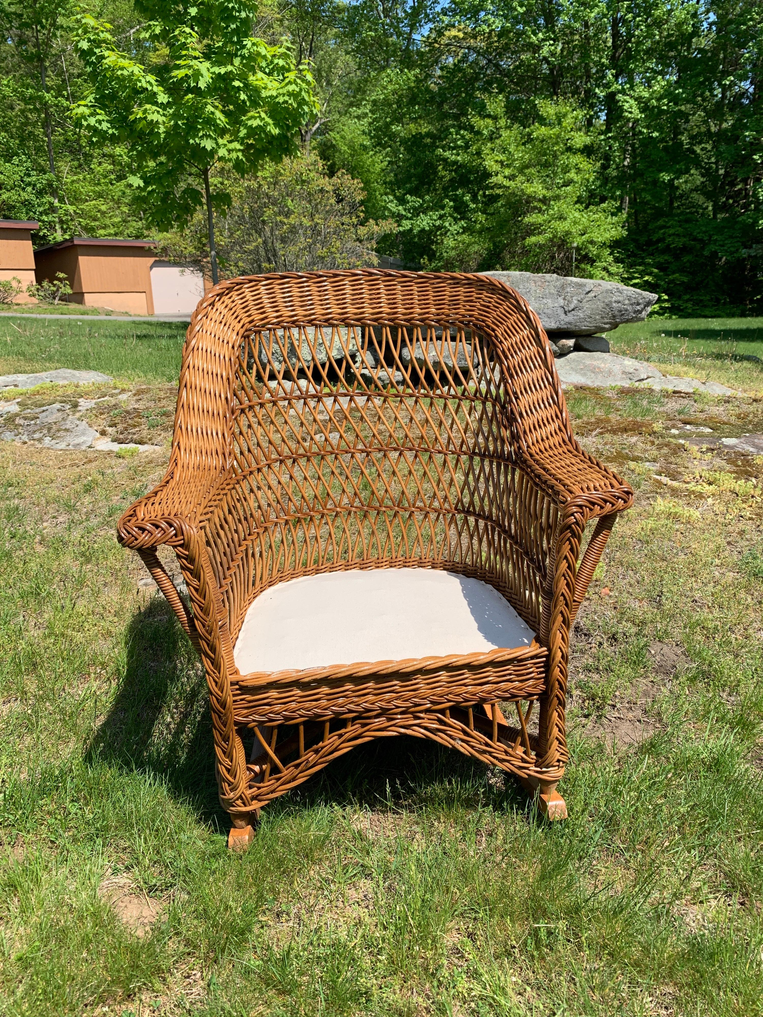 Vintage bar Harbor Wicker rocker in a natural stained finish. This piece measures 30.5” wide, 35” tall, and 33” deep.