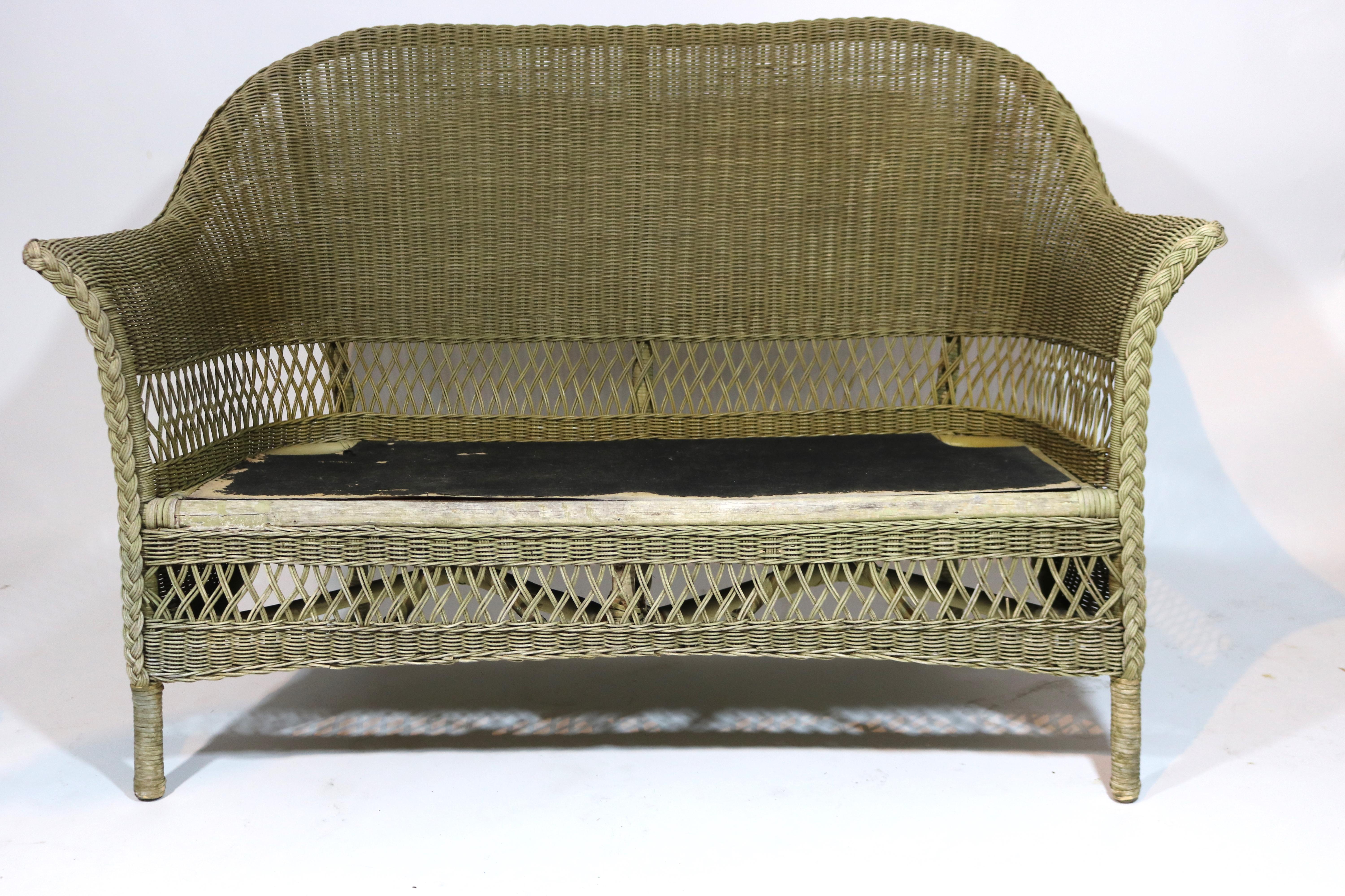 Antique bar Harbor Wicker settee/loveseat in triple cross pattern in a rich natural stain.
Wicker in very good condition with no breaks in wicker.
A thick tufted rose velvet loose seat cushion has fading.
Early 20th century, circa