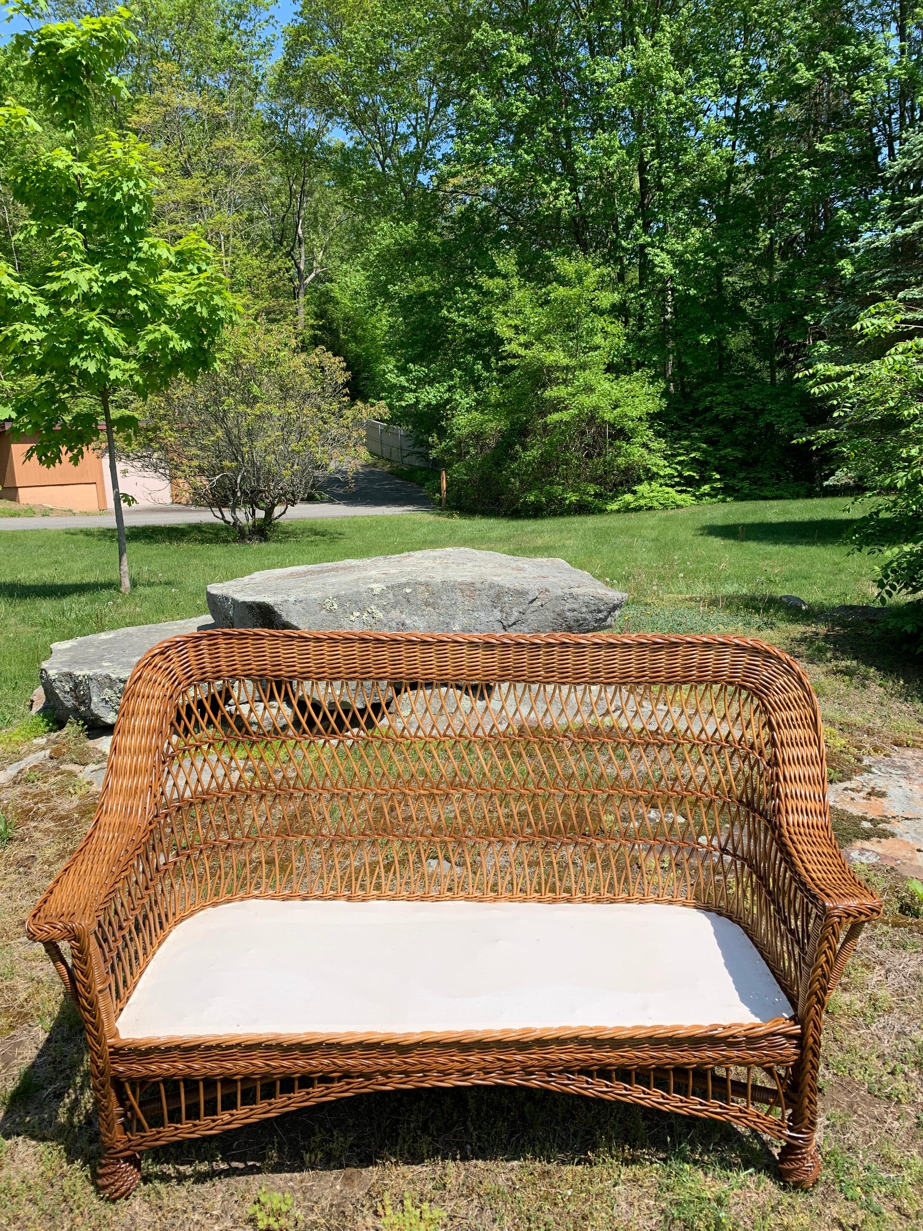 Vintage bar Harbor Wicker sofa in natural stain finish. Small in scale, this piece measures 61” long, 37.5” tall and 26” deep.