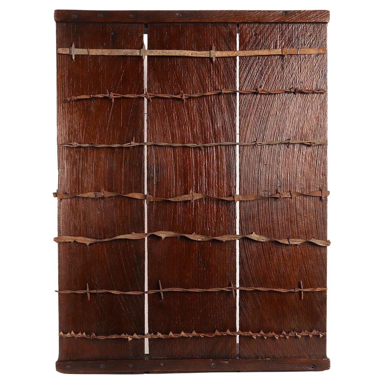 Antique barbed wire collection on wooden board, from USA, end of 19th century.