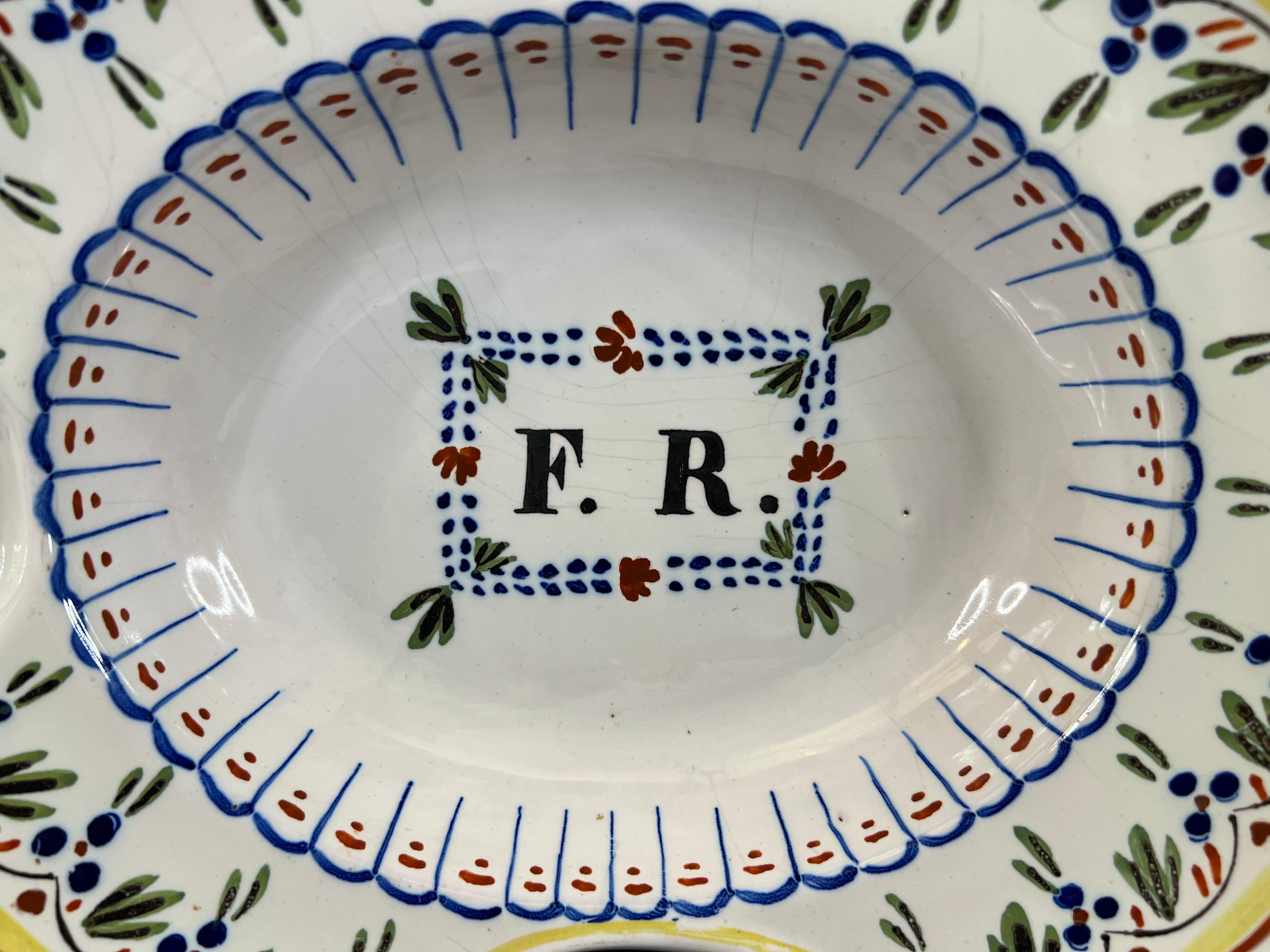 A stunning French faience barber's shaving bowl. beautifully decorated with monogram in its center, the letter F and R. It comes from French Nevers Bourgogne.

A male toilet object, the bearded dishes have a specific bowl shape. The lower part of