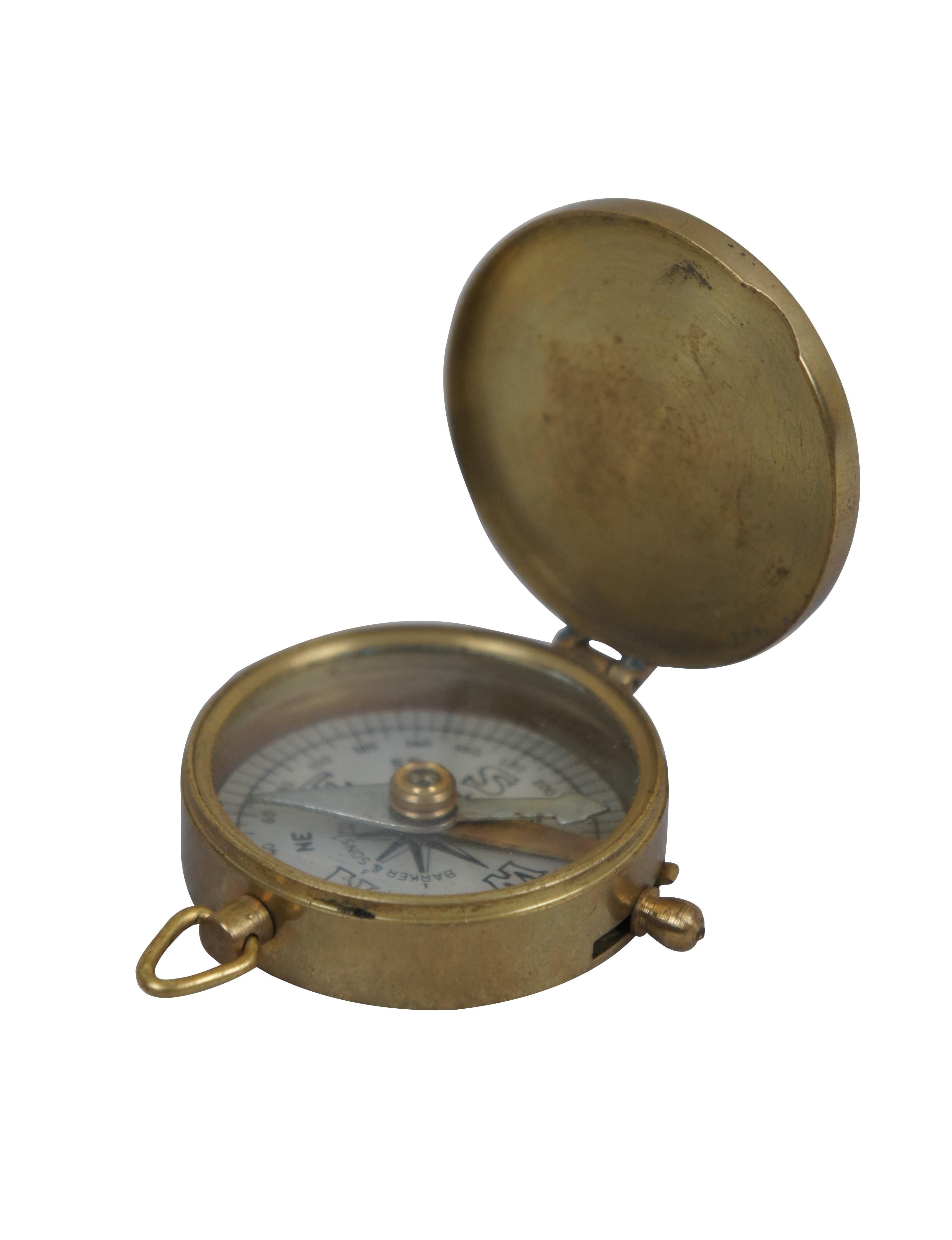 Early to mid 20th century compass by F. Barker & Sons Ltd of London. Brass case with white face and ring for suspending from a watch fob / chain.

