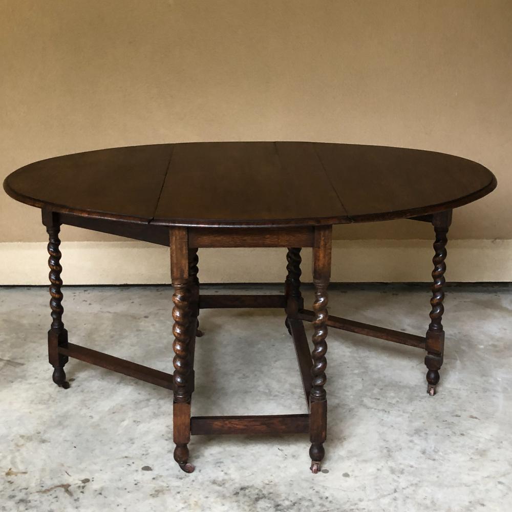 Antique barley twist gateleg drop-leaf table provides the essence of why this table design has been so popular for all these centuries. Perfect as a sofa table or tucked away against the wall when not in use, it features two independent spacious