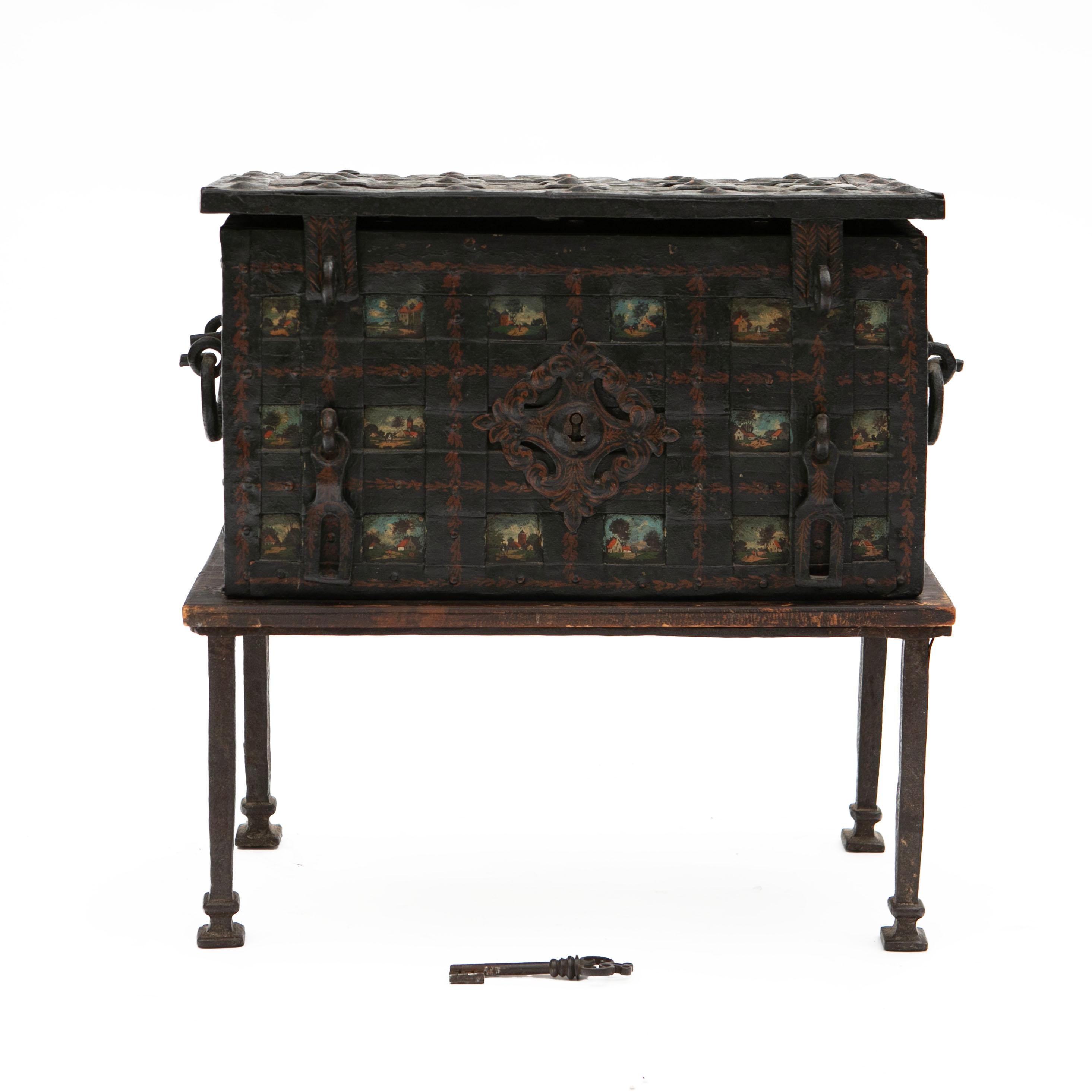 A baroque period iron armada strongbox, or traveling safe, in its original condition, showcasing a beautiful natural patina.

This coffer is richly decorated with small polychrome landscape scenes depicting houses, animals, people, etc. It features