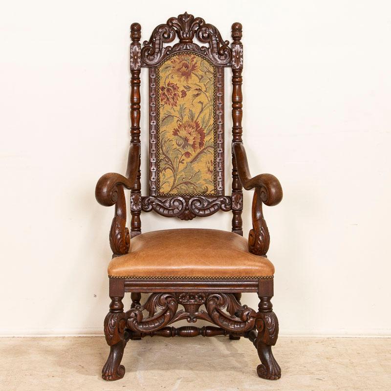 This handsome arm chair is an excellent example of Danish baroque carving; notice the curve of the arms, turned columns and carved crown and feet. The leather seat and upholstered back create and enduring look that will remain classic and