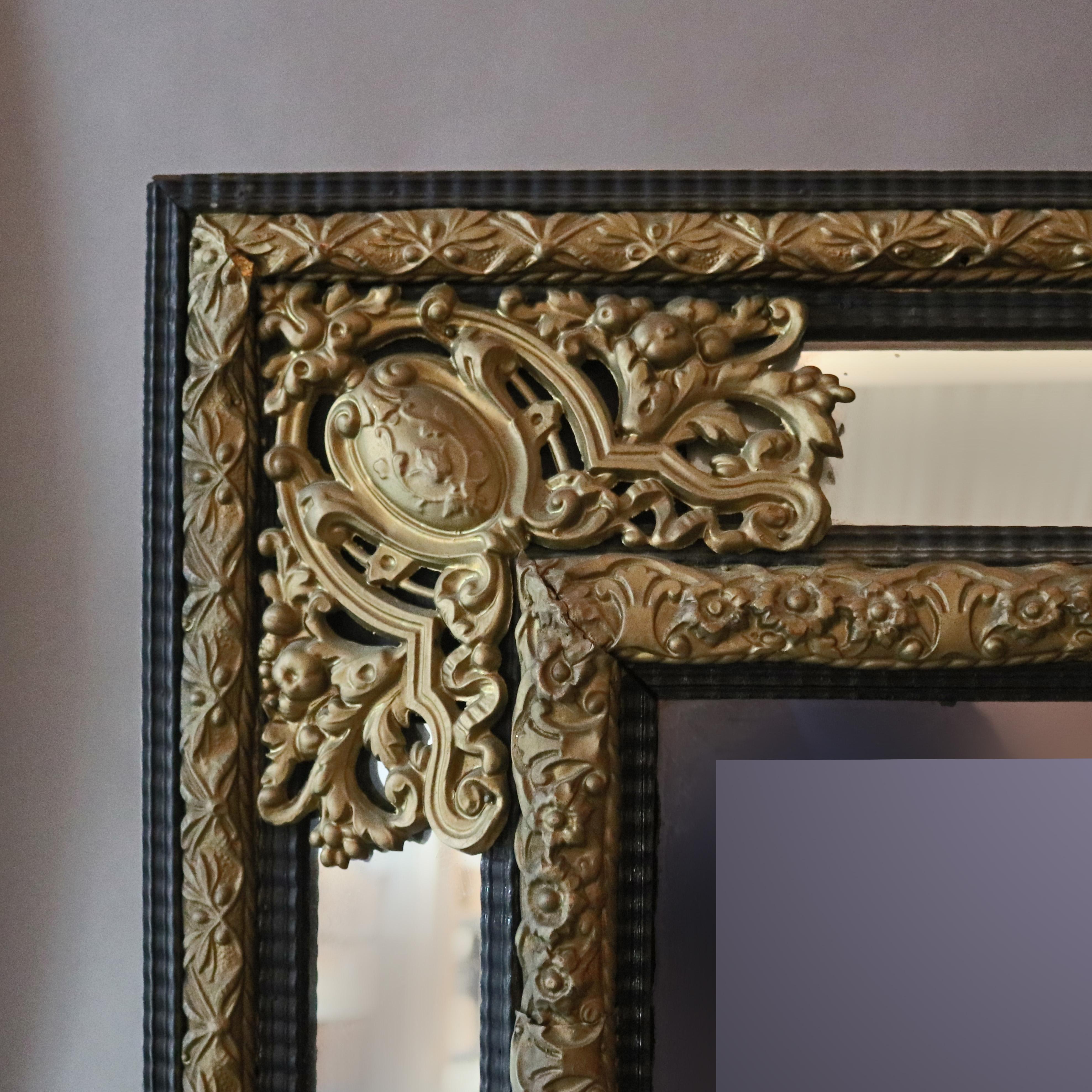 An antique baroque parclose wall mirror offers ebonized wood base with foliate and scroll pierced filigree bronzed mounts, central beveled mirror, elements of Persian designing, circa 1890.

Measures: 38