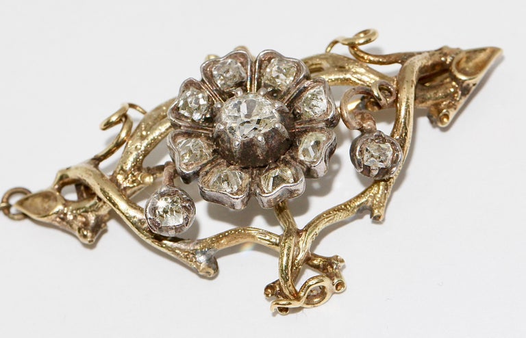 Antique, Baroque Gold Diamond Brooch.

The central diamond weighs about 0.45 carat.
The brooch also has a safety pin.