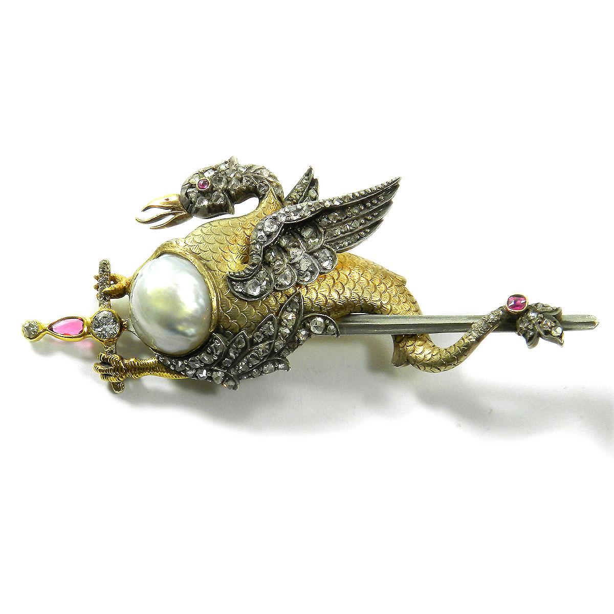 Antique baroque pearl and diamond dragon Brooch in Gold circa 1890

Very decorative brooch in the form of a dragon riding a silver sword, the scaled decorated body set with a baroque pearl, the head and wings set with countless diamond roses, the