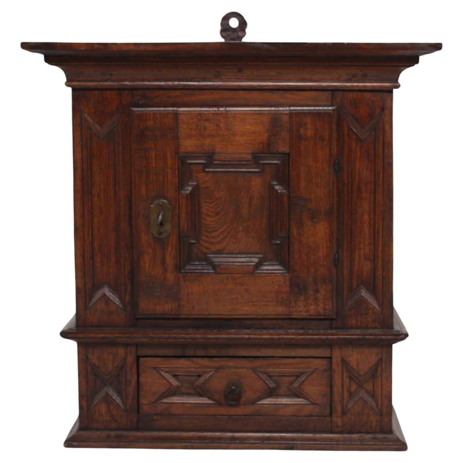Antique Baroque Style Hanging Cabinet of Dark Oak with Wood Carvings ca. 1800