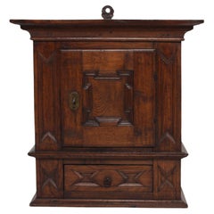 Antique Baroque Style Hanging Cabinet of Dark Oak with Wood Carvings ca. 1800