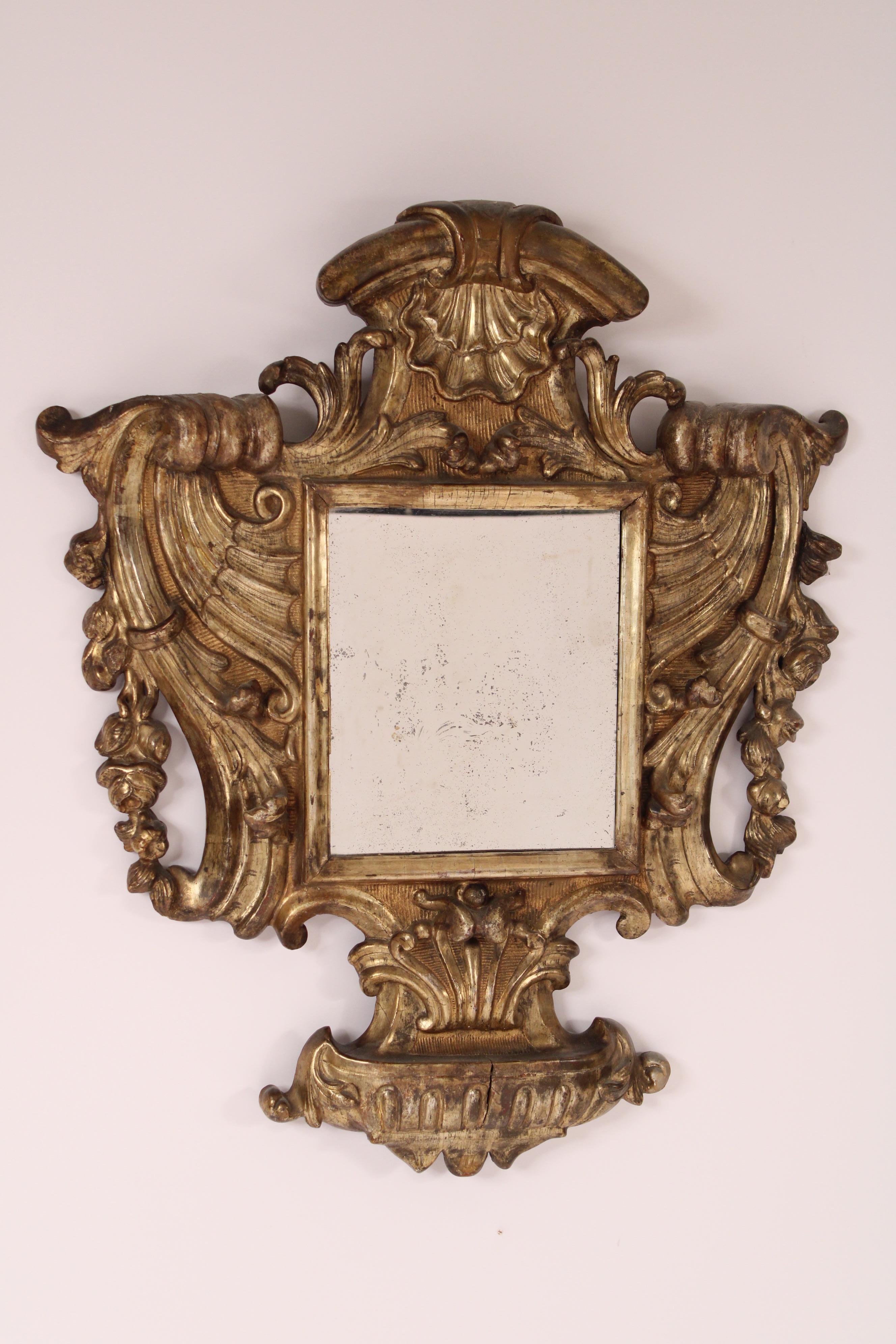 Antique baroque style silver leaf mirror, 19th century. With seashell, floral, gadroon and scroll carvings.
