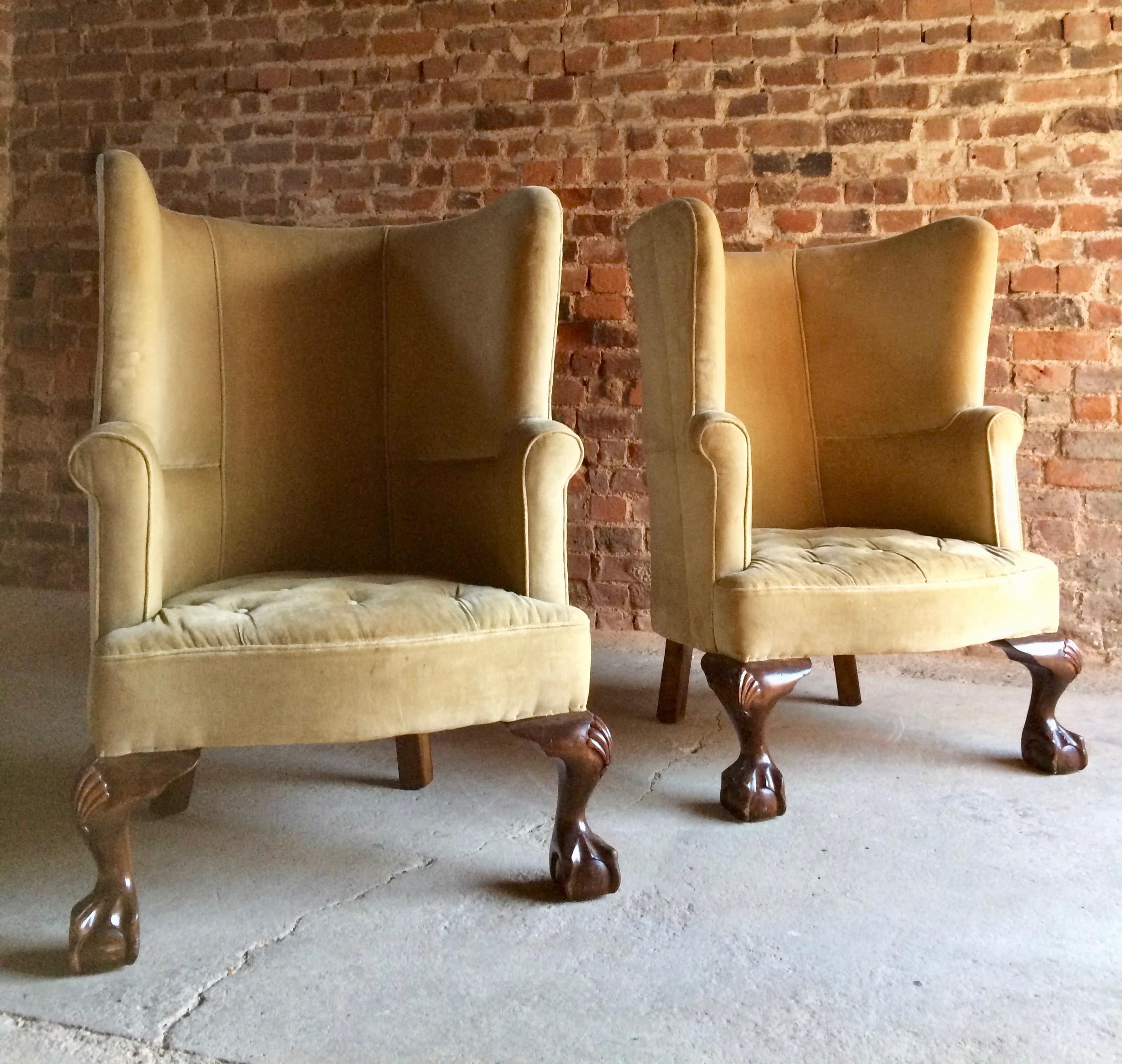 A stunning pair of 19th century George II style mahogany barrel back porters armchairs dating to circa 1860, the chairs upholstered in gold velvet, standing on oversized carved ball and claw cabriole legs, these chairs are breathtakingly beautiful