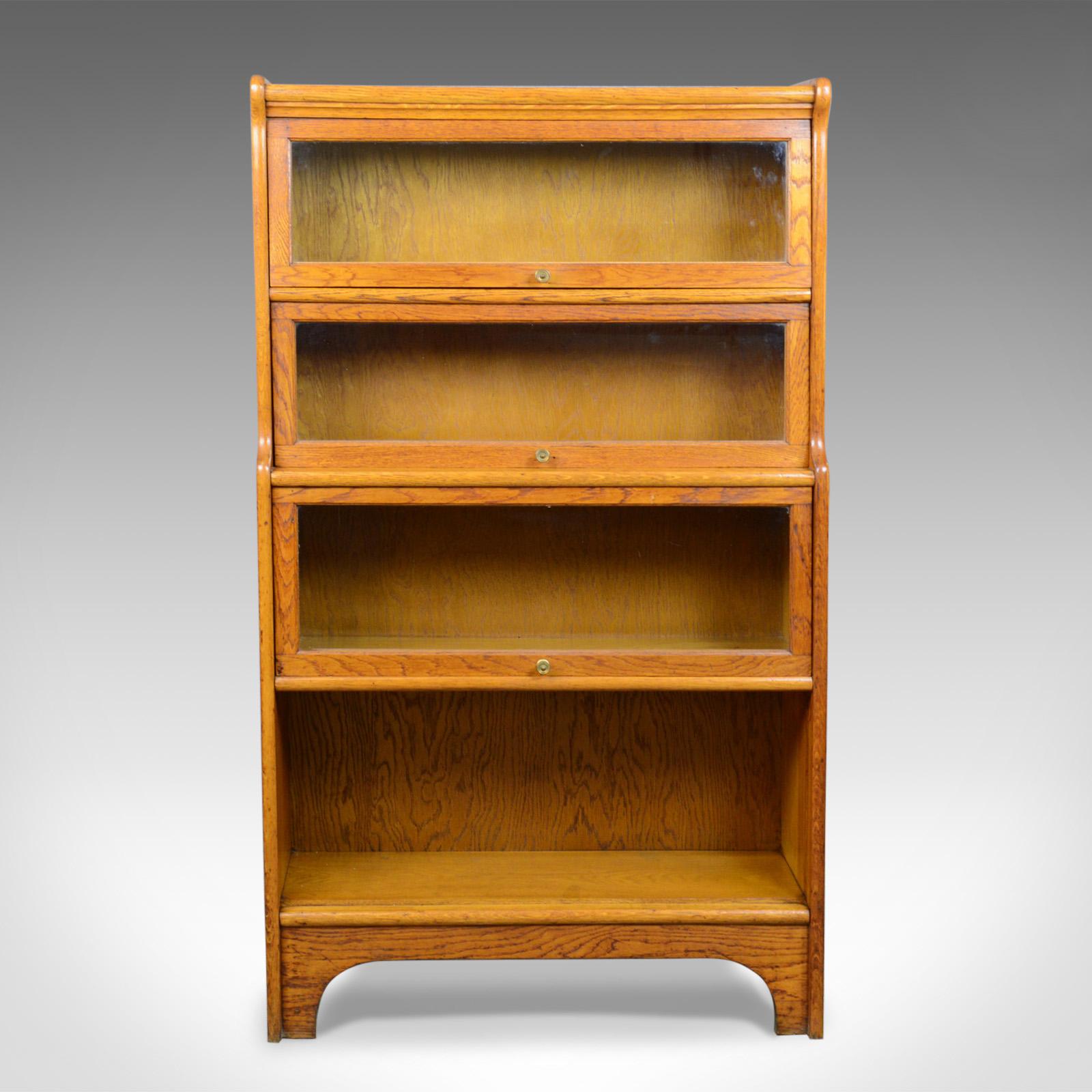 This is an antique bookcase, a four section, glazed, Globe Wernicke taste barrister's book shelf in English oak dating to the Edwardian era, circa 1910.

Oak with delicious honey tones in a wax polished finish
Grain interest throughout displaying
