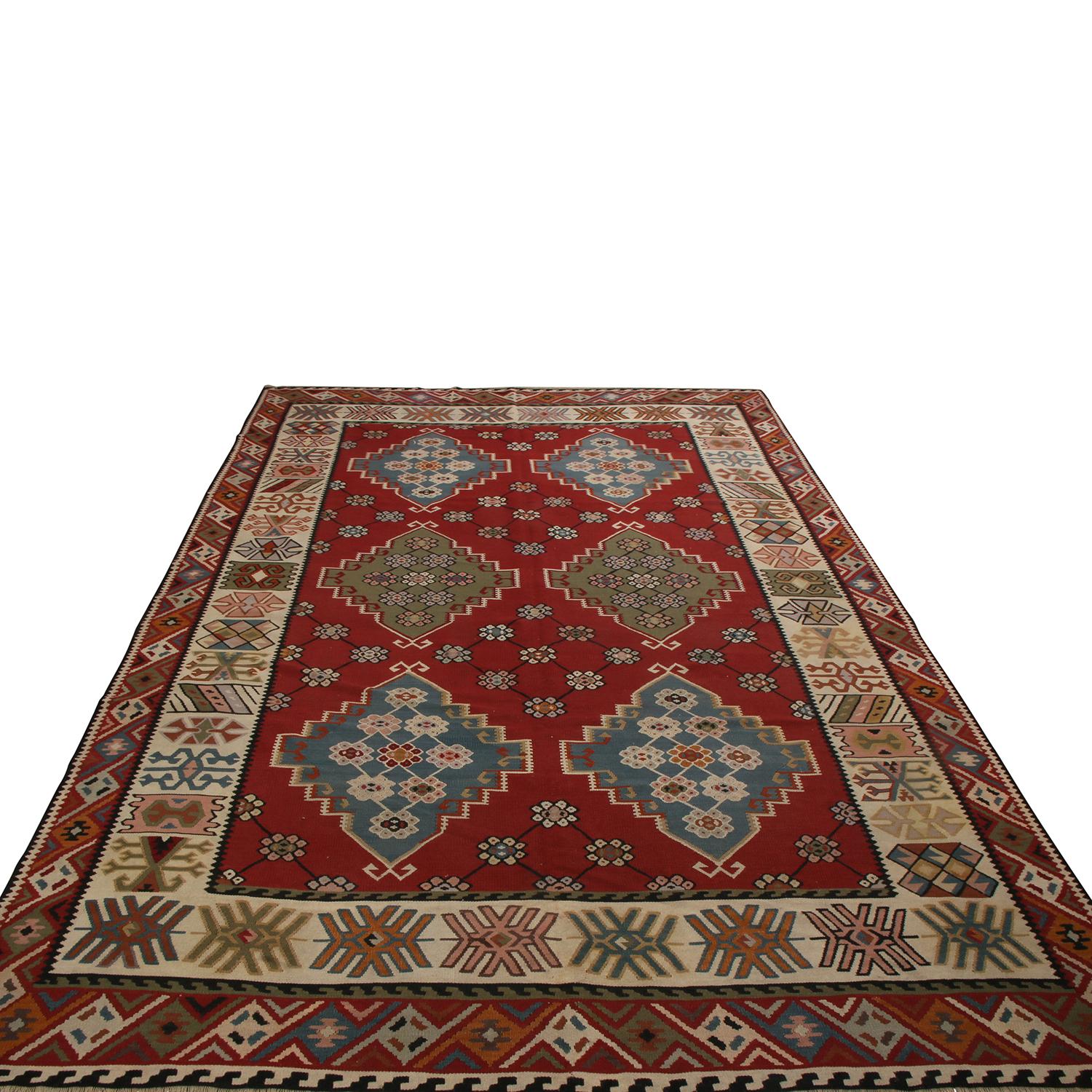 Flat-woven in Turkey between 1890-1900, this antique Basra Kilim features a tasteful marriage of oriental influences in its pattern and colorways, enjoying high-quality wool in excellent condition among its kind. The rich burgundy background, a