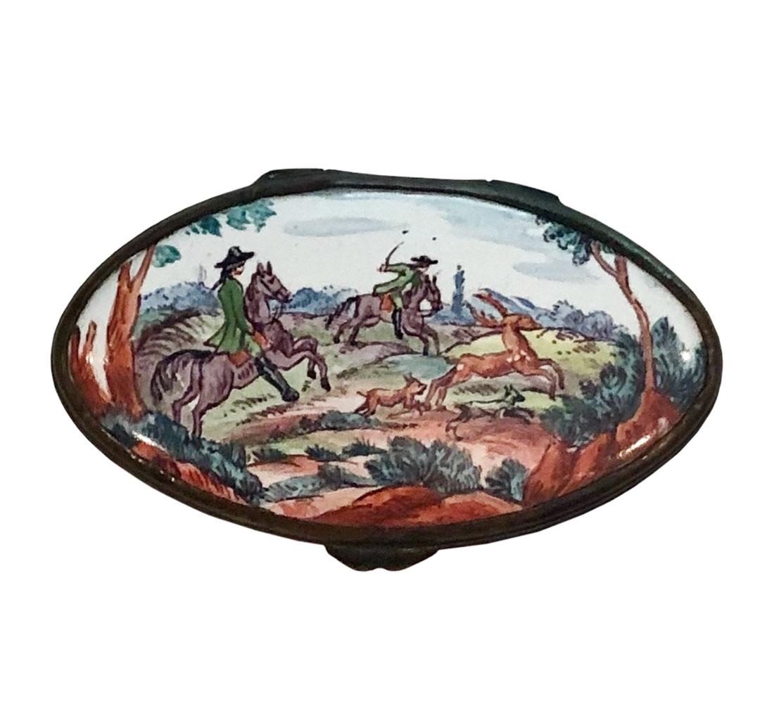 A wonderful 18th century Battersea box depicting a hunting scene with hunters on horseback with dogs, deer and boar depicted against a wooded background.