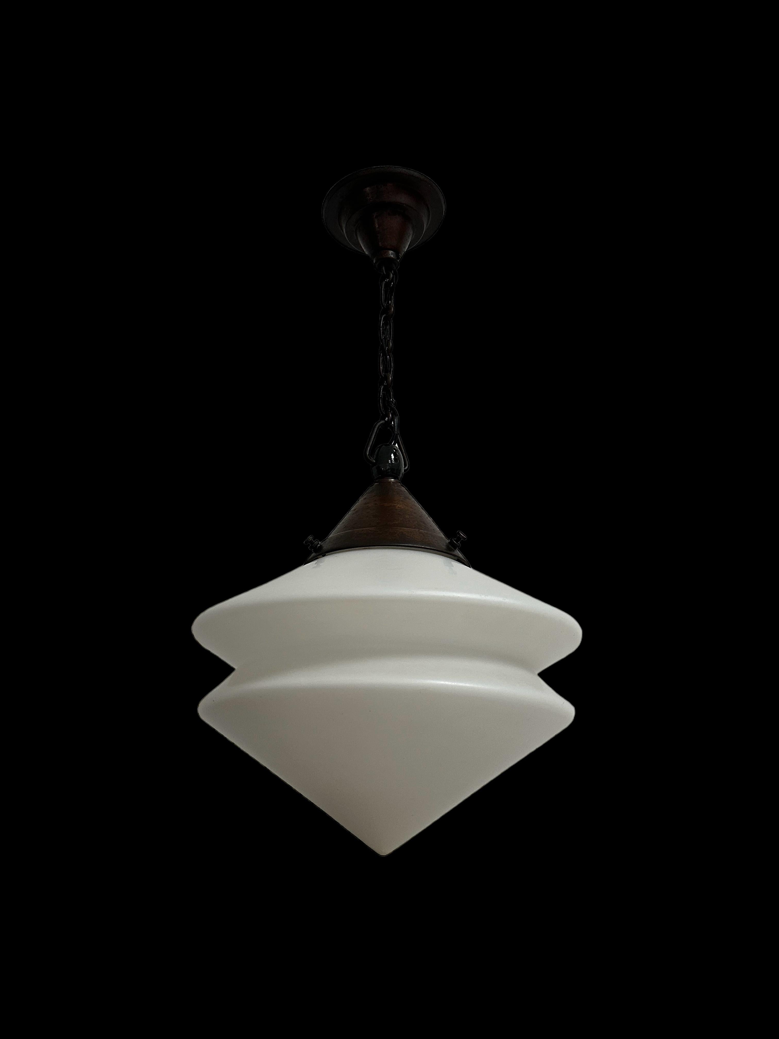 - An original and extremely rare satin opaline Bauhaus ceiling pendant by Kandem, Germany circa 1920.
- A remarkable triangular design to the glass in an incredible condition for its age, the gallery manufactured in ornate steel and porcelain and