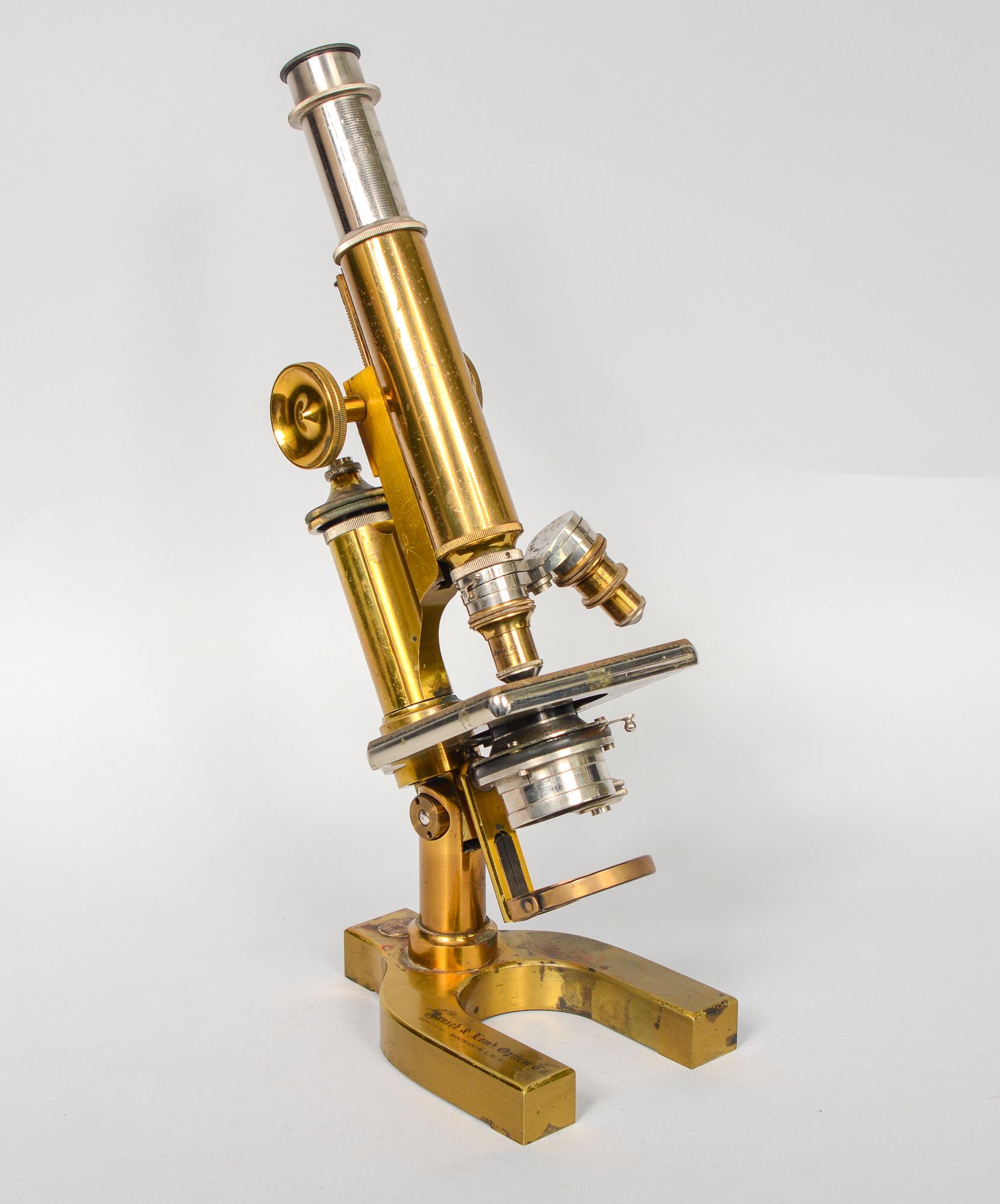Brass Bausch and Lomb microscope. This has a patent date of February 16, 1897. This microscope has two objectives. The box this is in may not be the correct one. The dimensions listed are for the box. The microscope is 4.25 inches deep, 6 inches