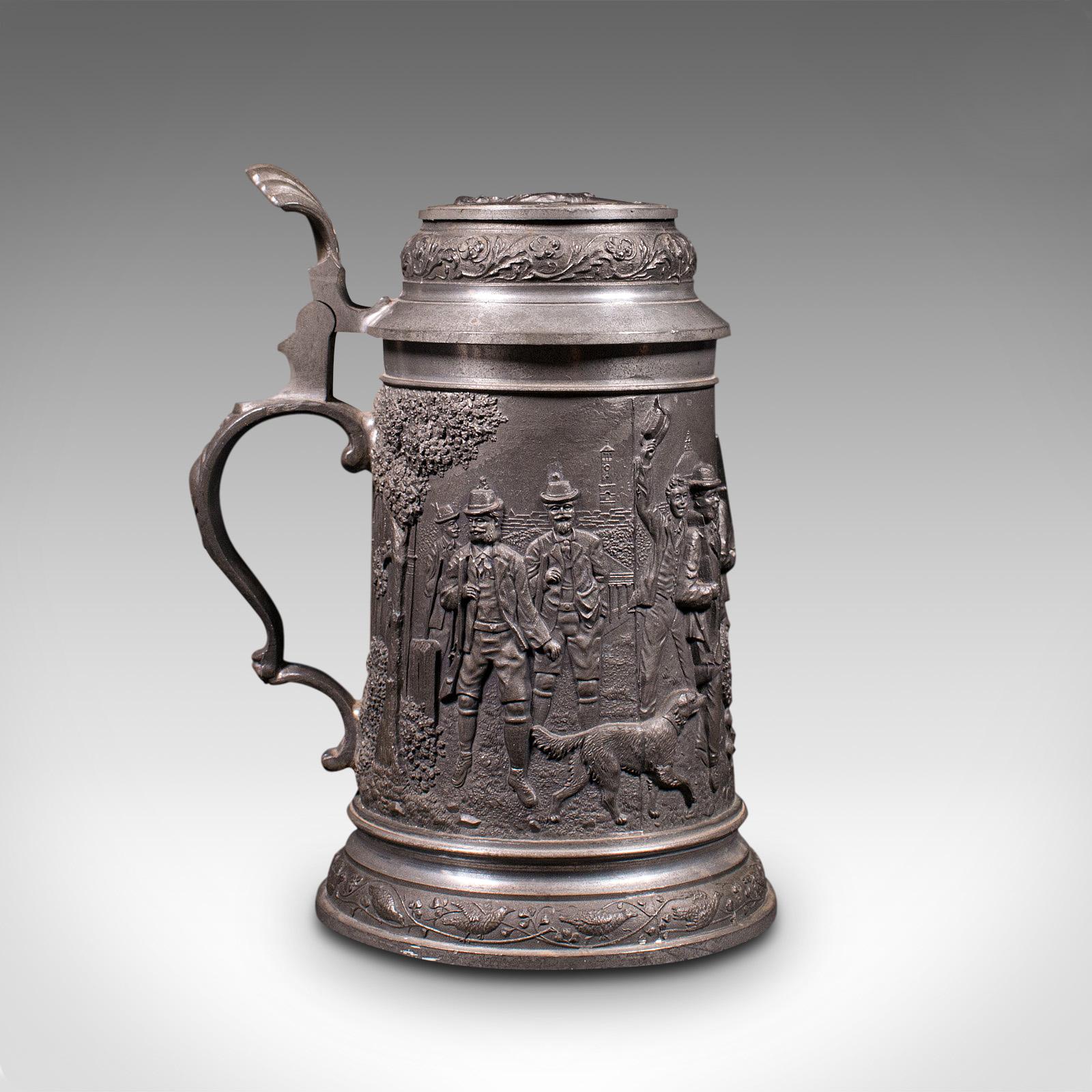This is an antique Bavarian beer stein. A German, pewter jug with decorative relief, dating to the early 20th century, circa 1920.

Superb craftsmanship extolled by the striking relief detail
Displays a desirable aged patina
Pewter body in very