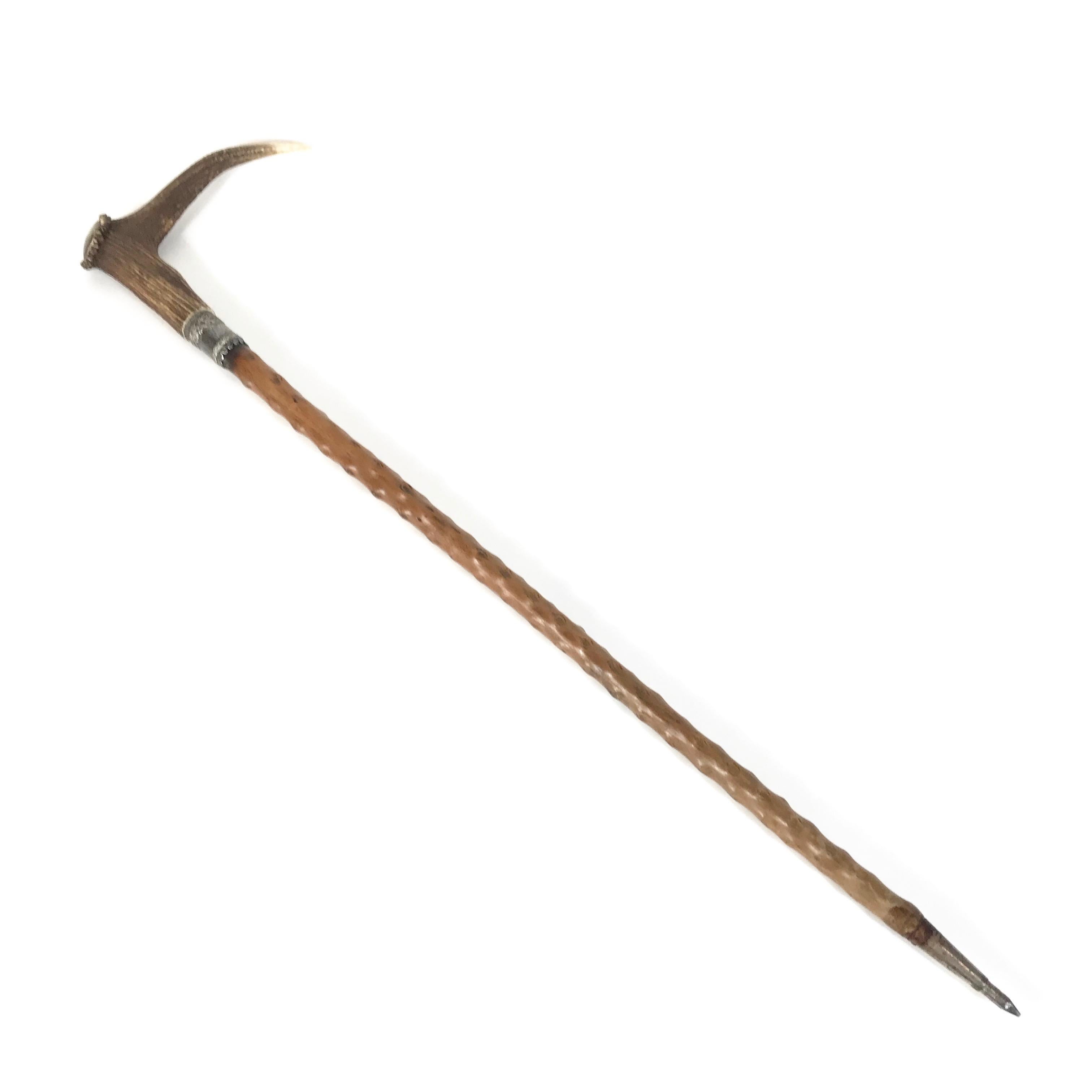 Unique Bavarian hunting walking cane from the early 20th century - the walking cane is handmade of blackthorn wood, featuring a deer antler handle with silver chiselled collar and personalized plaque H.B.