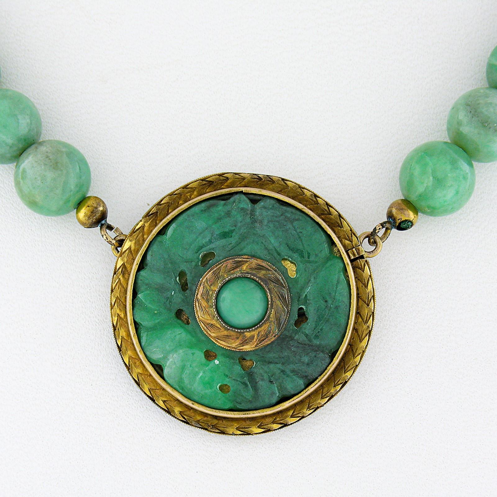 Here we have an absolutely gorgeous antique green Jade bead strand necklace that features an incredible carved Jade pendant set in solid 14k yellow gold. The Jade on this pendant has been masterfully carved into a lovely flower design, showing