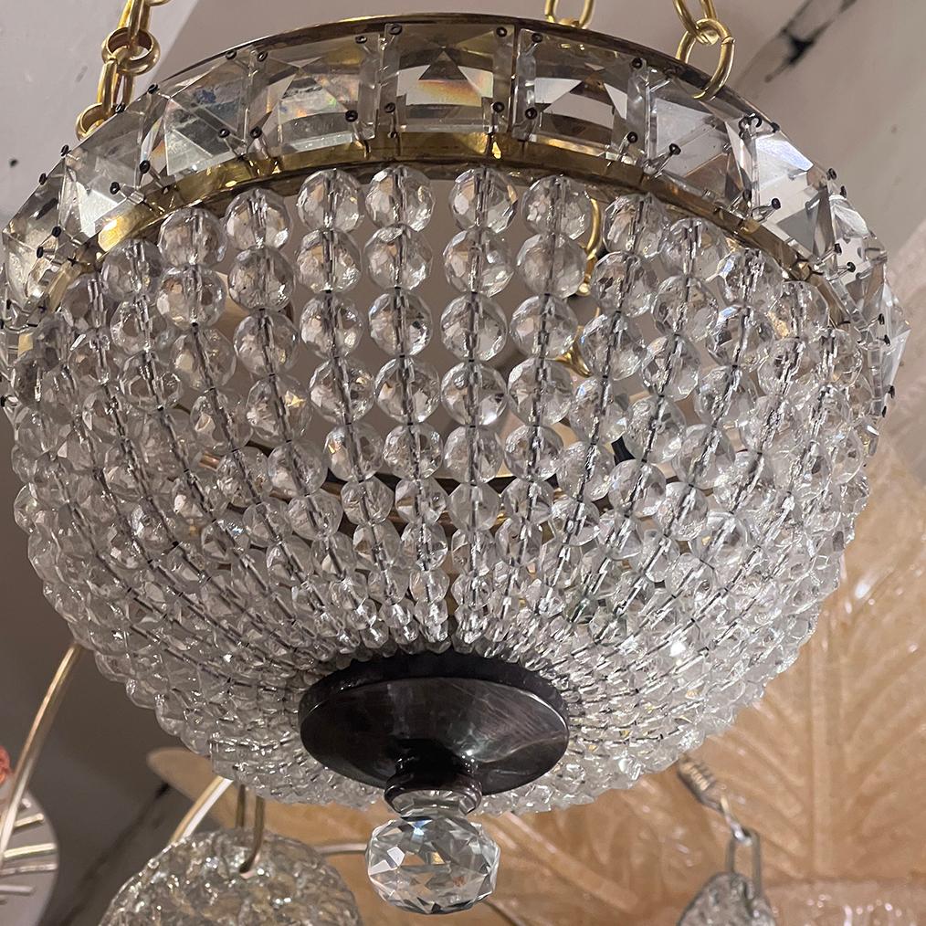 A circa 1920's French beaded crystals light fixture with 2 candelabra interior lights.

Measurements:
Present drop: 20