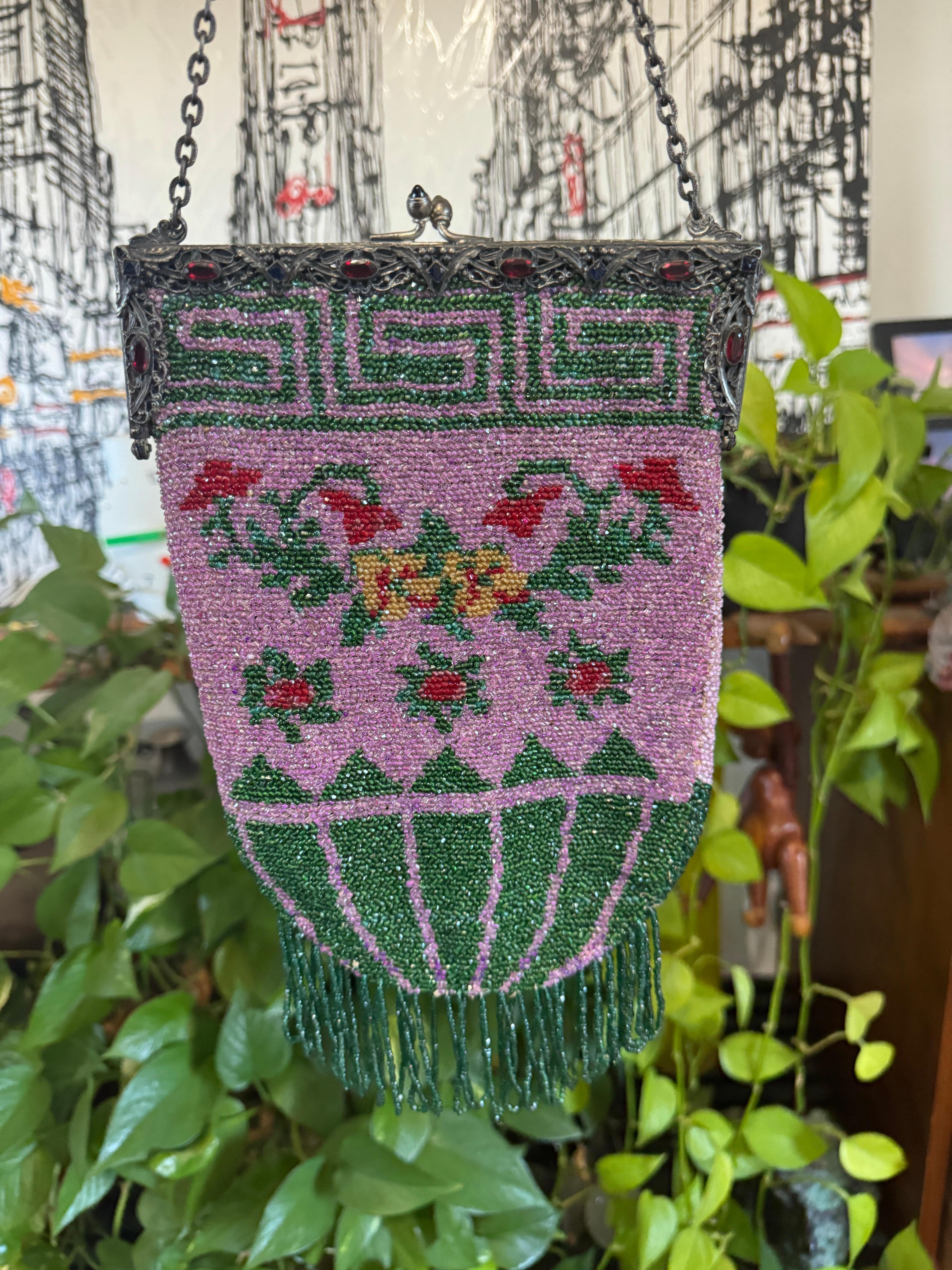 This is an amazing handbag, lined in silk. Most likely french. Fabulous colorway on this, purple, green and red, just stunning!!  Cabochons stones on the frame in Red and blue. Ornate frame on this, with green Cabs on the clasp. Shuts tight.  This