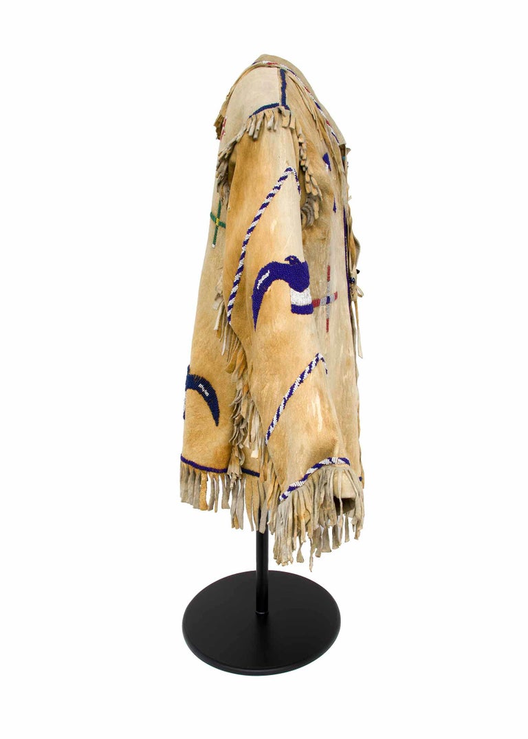Antique Native American Pictorial jacket style beaded shirt with tie closures, Apache (Plains Indian). Late 19th to early 20th century, circa 1890-1910, this shirt is constructed of native tanned hide and partially beaded in glass trade beads.