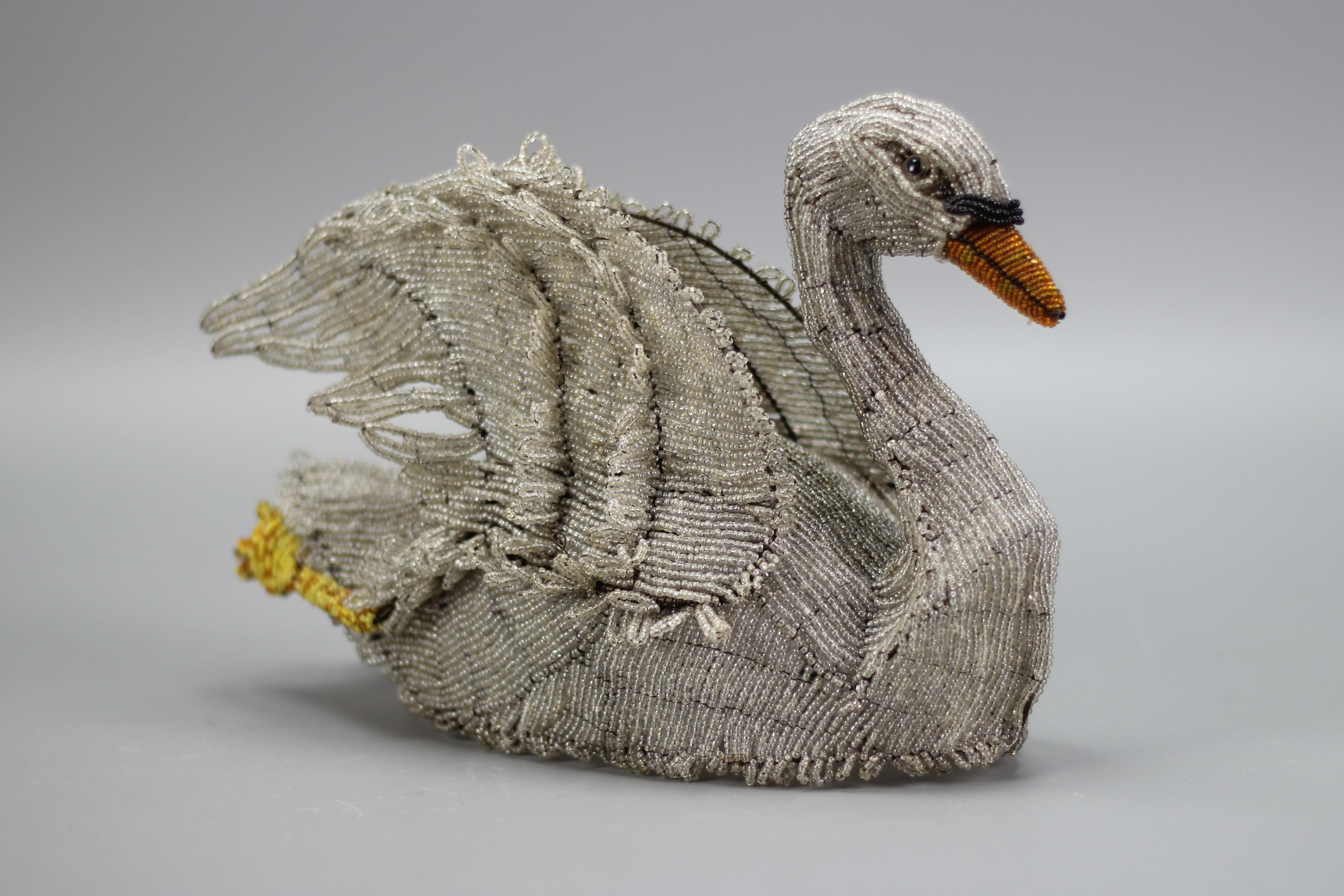 An antique figure of a swan made of glass beads, Germany, late 19th century.
Absolutely adorable and unique handmade figure of a swan features exquisite beadwork with lifelike details in white, yellow, orange, and black.
Beautiful and very