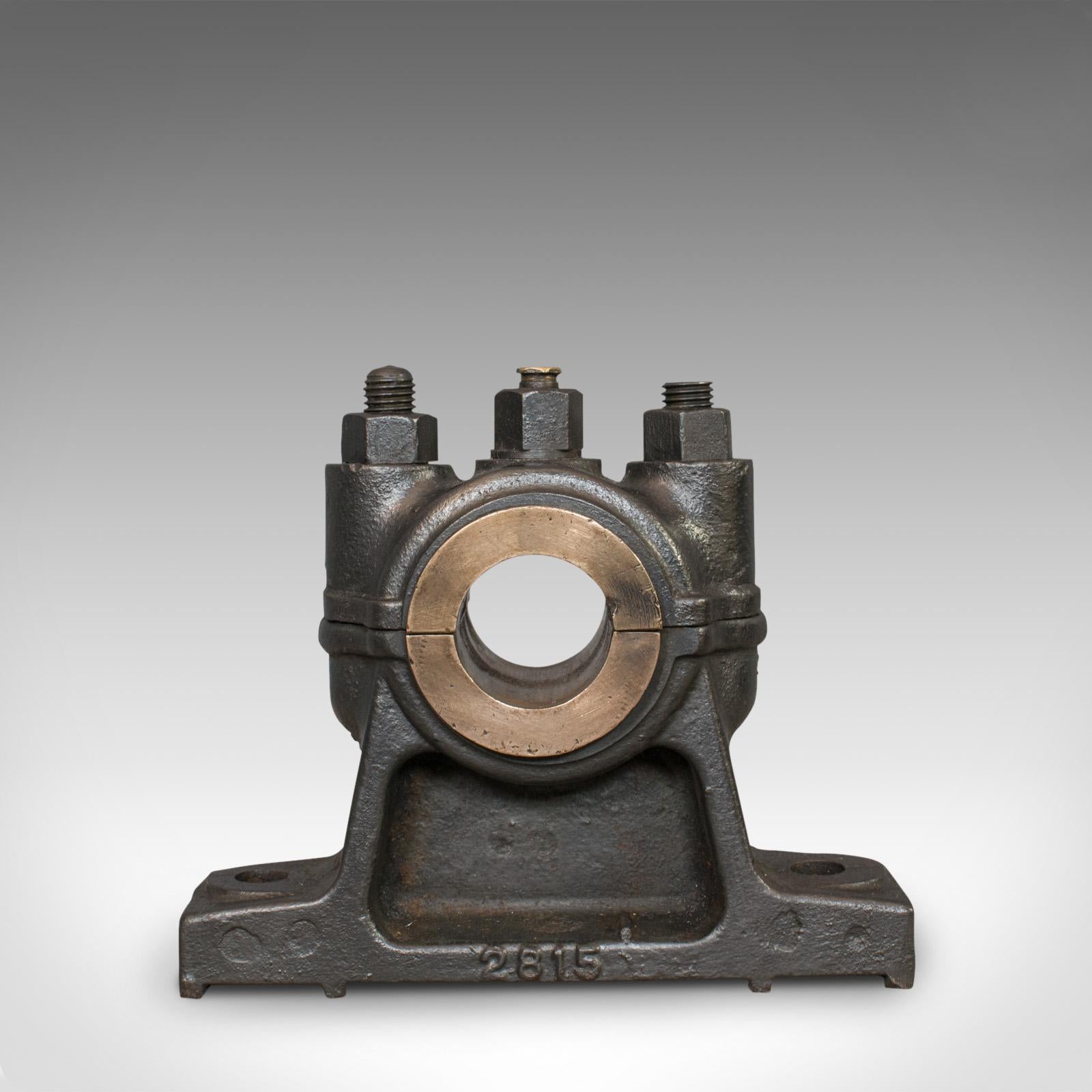 This is an antique engine bearing with graphite finish. An English, cast iron and bronze desk ornament or paperweight, and dating to the Victorian period, circa 1900.

In fine form and of high mechanical interest
Displays a desirable aged