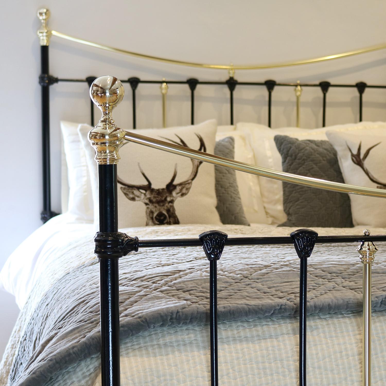 Cast iron and brass bedstead in black with attractive cast iron mouldings and curved brass top rails. 

This bed accepts a UK king size or US queen size (5ft, 60in or 150cm wide) base and mattress set.

The price includes a standard firm bed